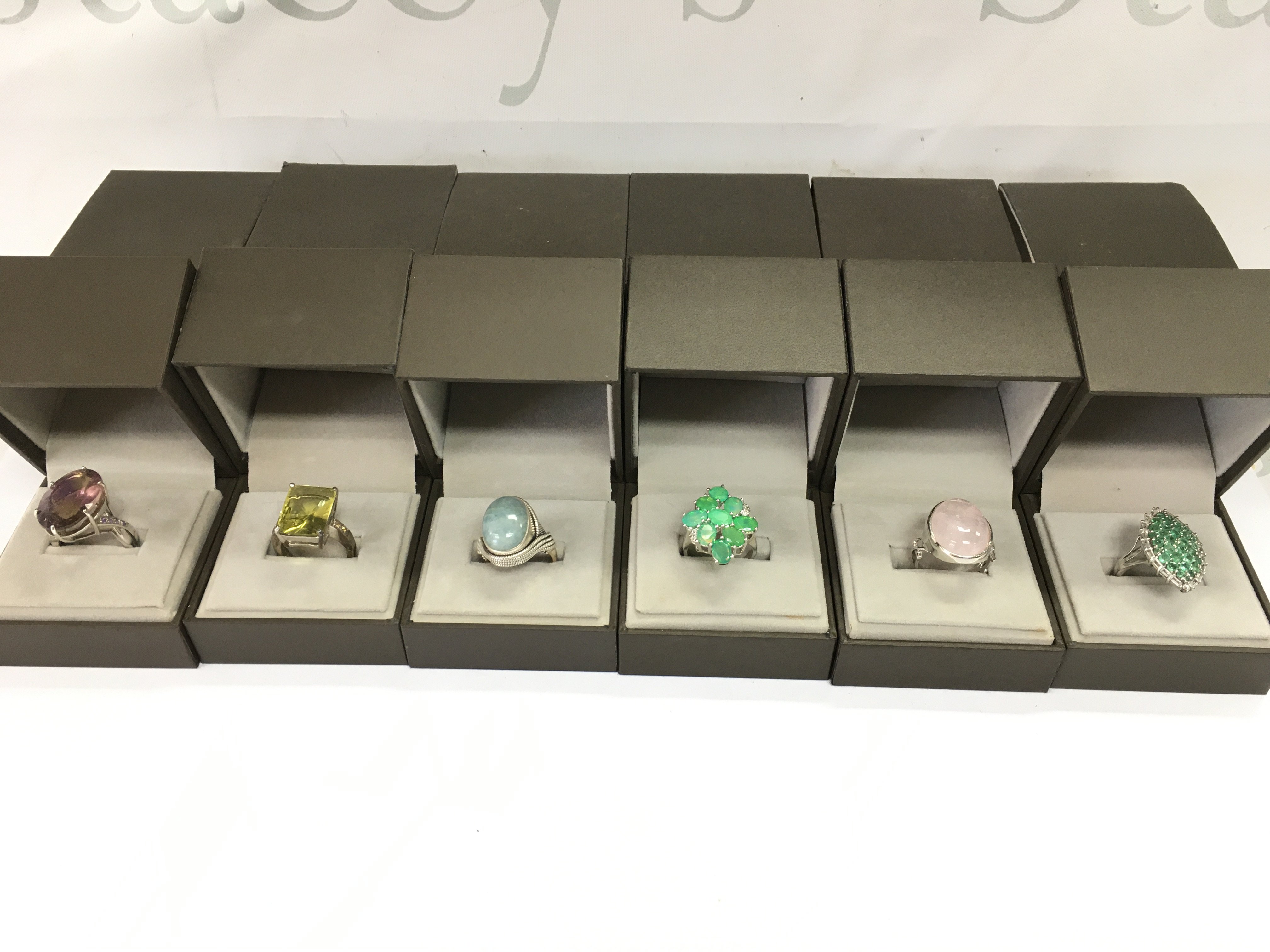 A collection of 6 assorted silver rings set with various stones. Postage B