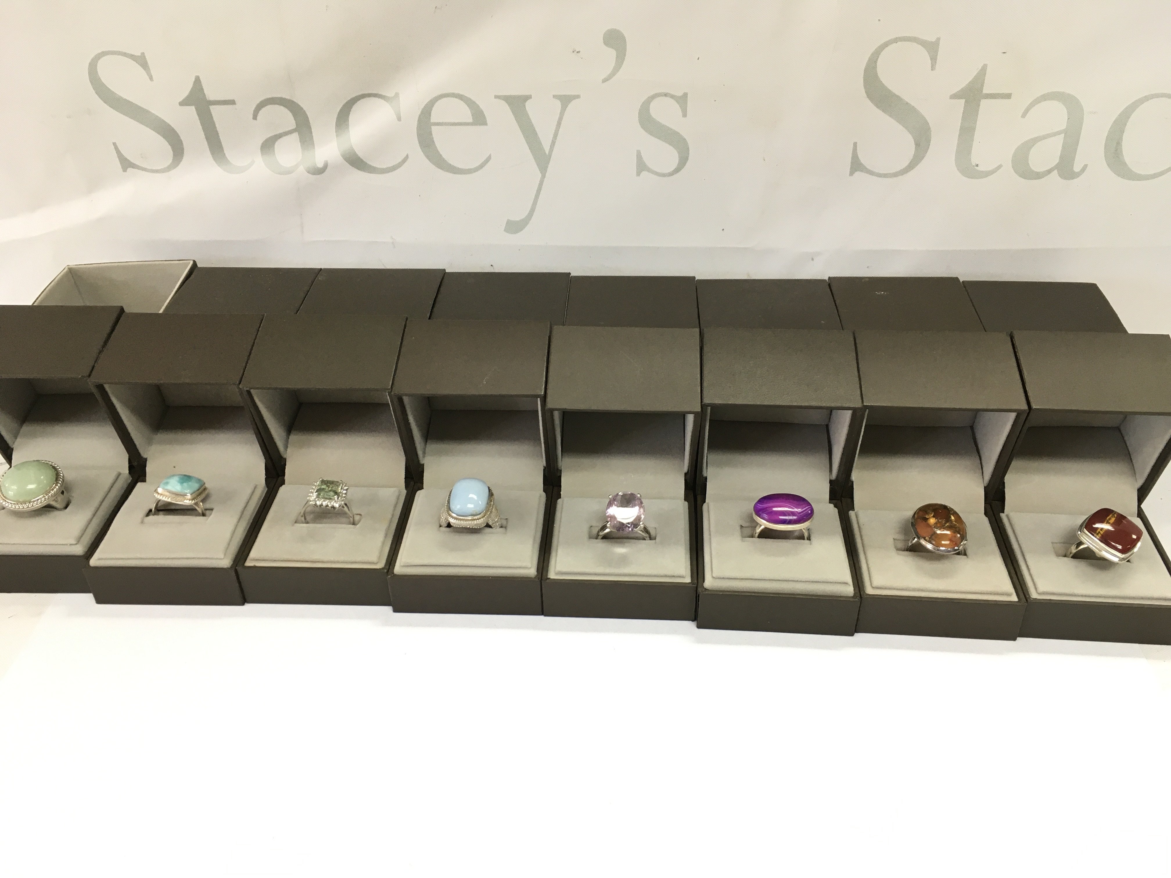 A collection of 8 assorted silver rings set with various stones. Postage B