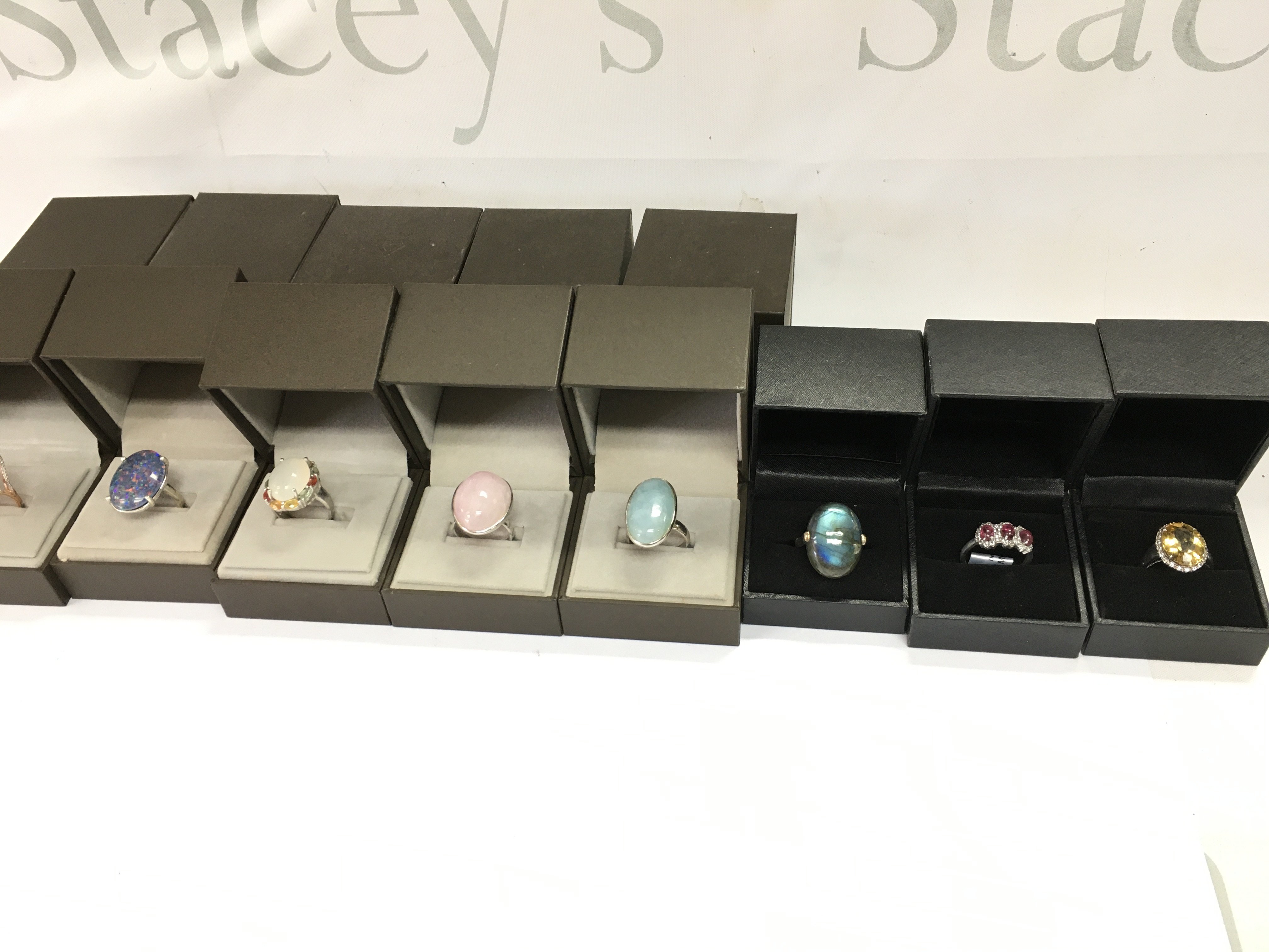 A collection of 8 assorted silver rings set with various stones. Postage B