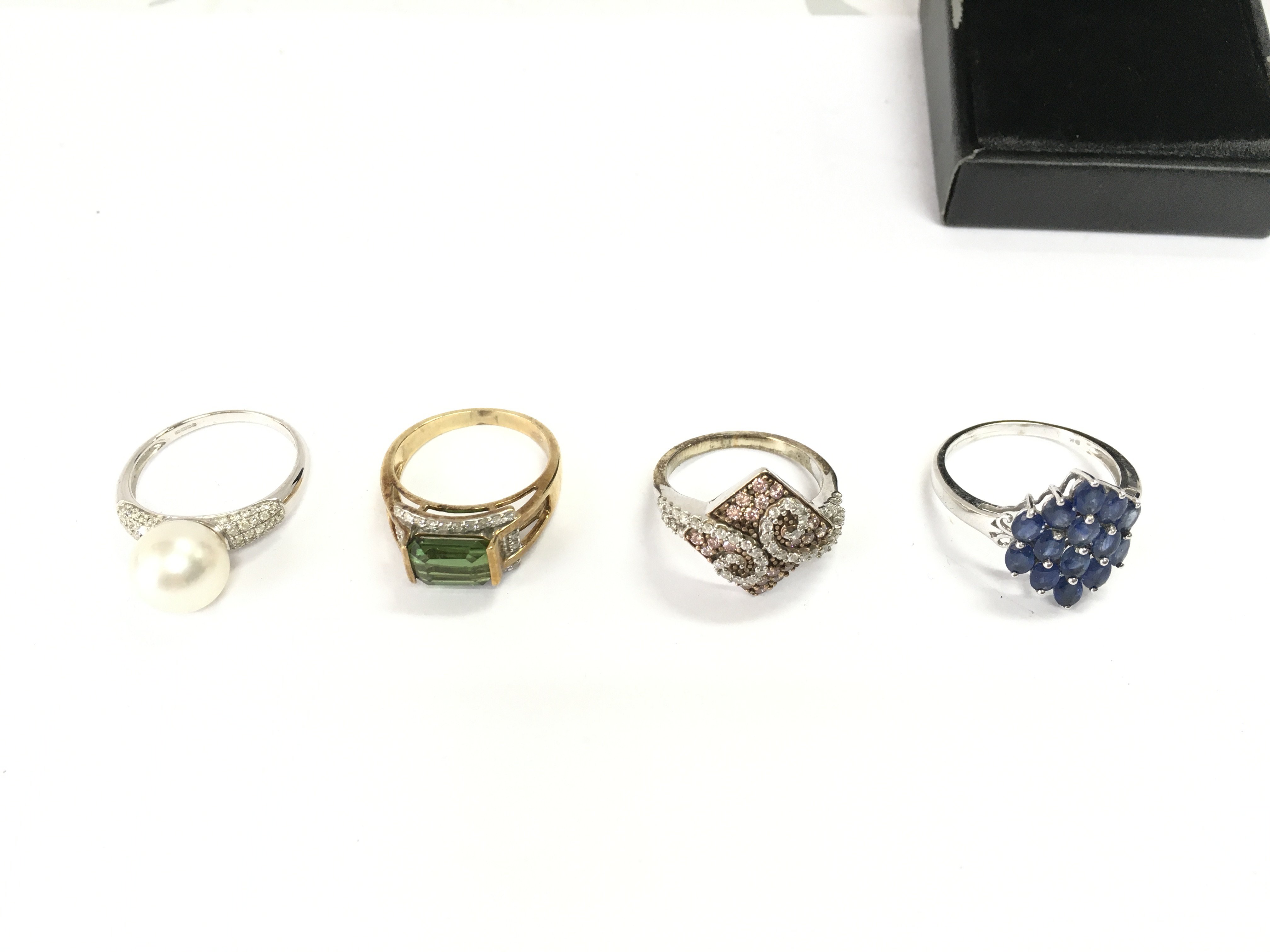Collection of four 9ct gold rings set with various stones. 17.62g