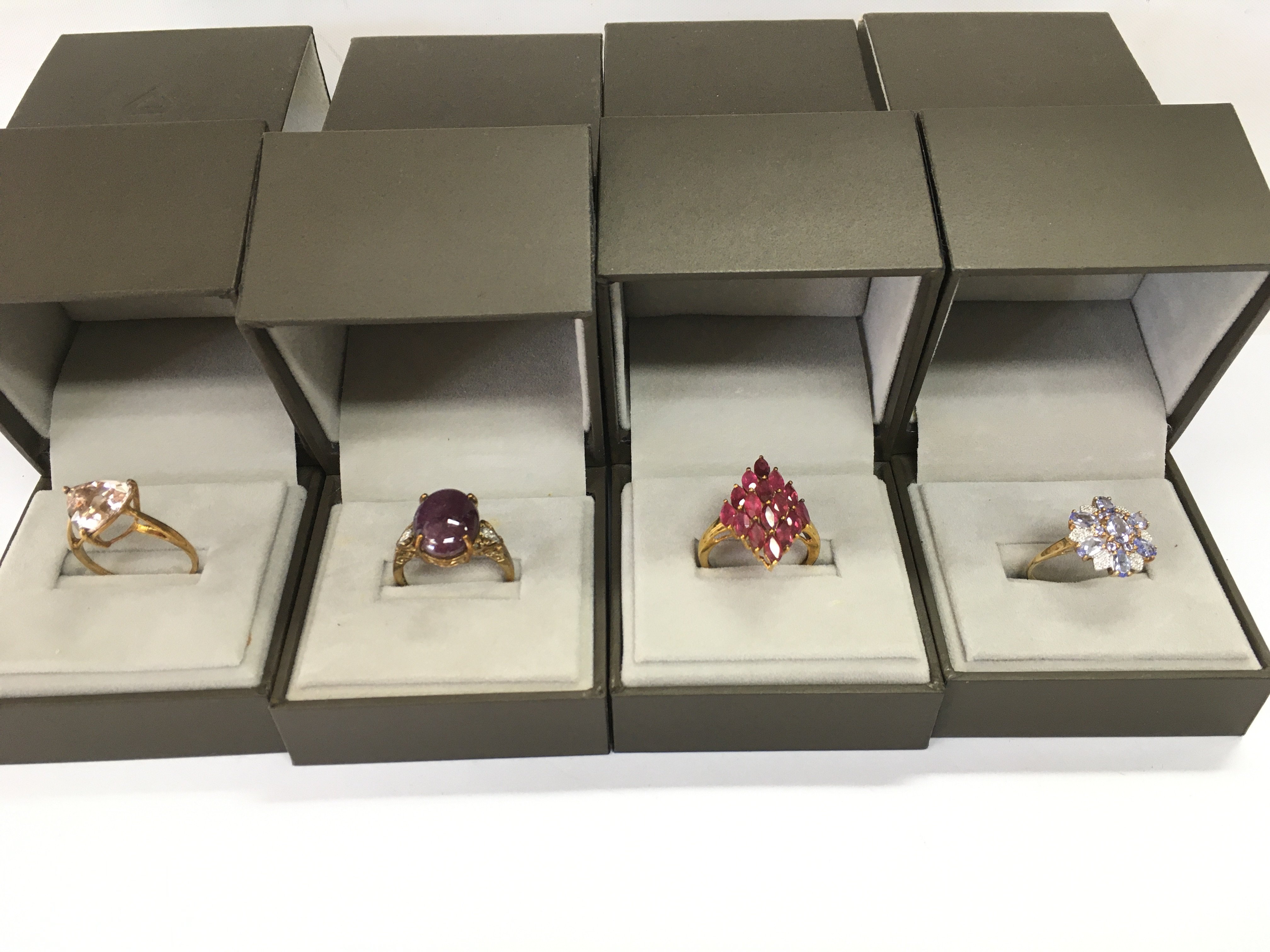 A collection of four 9ct gold rings set with assorted stones. 15.27g Postage B
