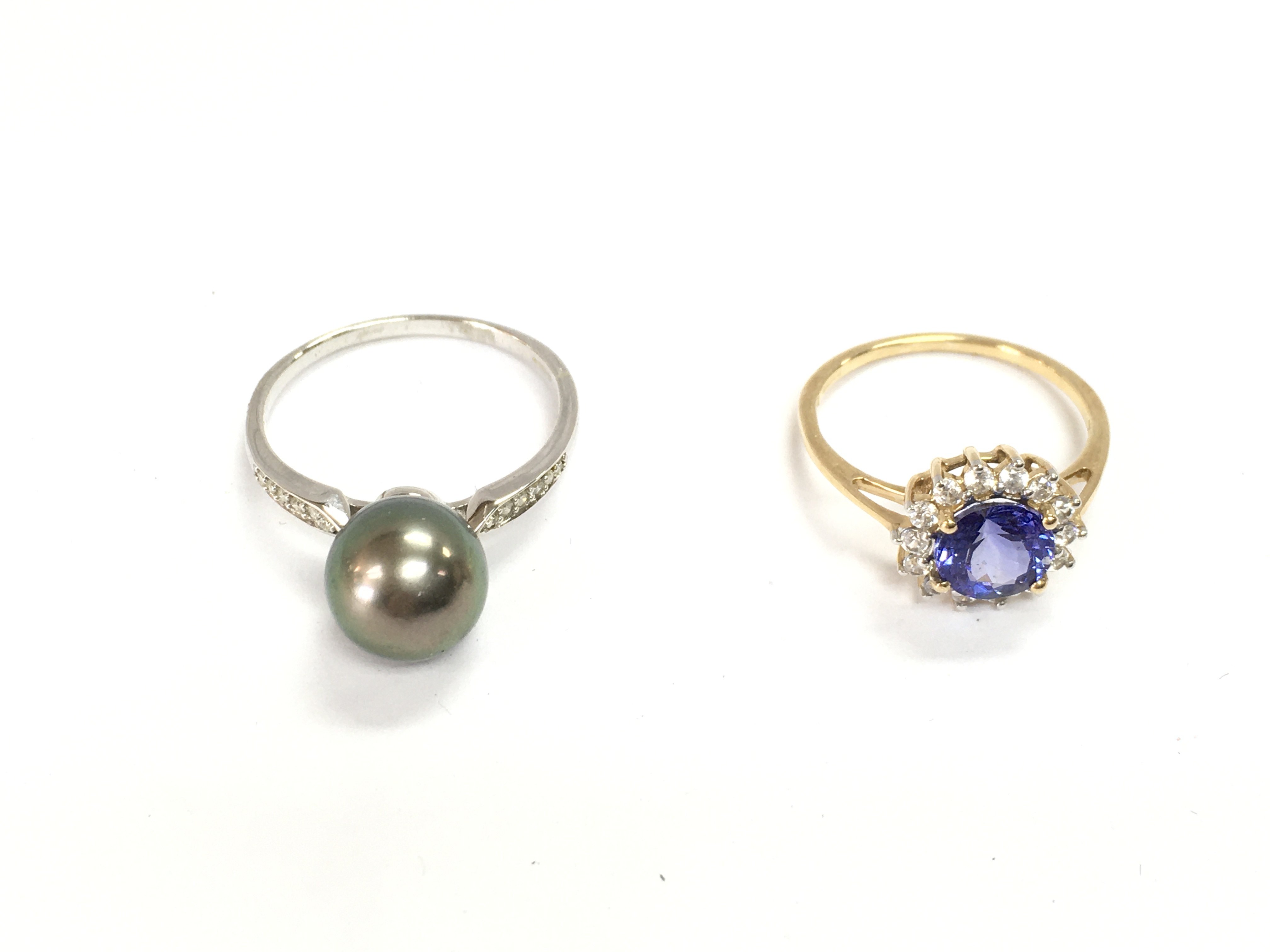 An 18ct white gold ring set with pearl 3.5g and size S and a 14ct yellow gold stone set ring 2.37g size N 1/2