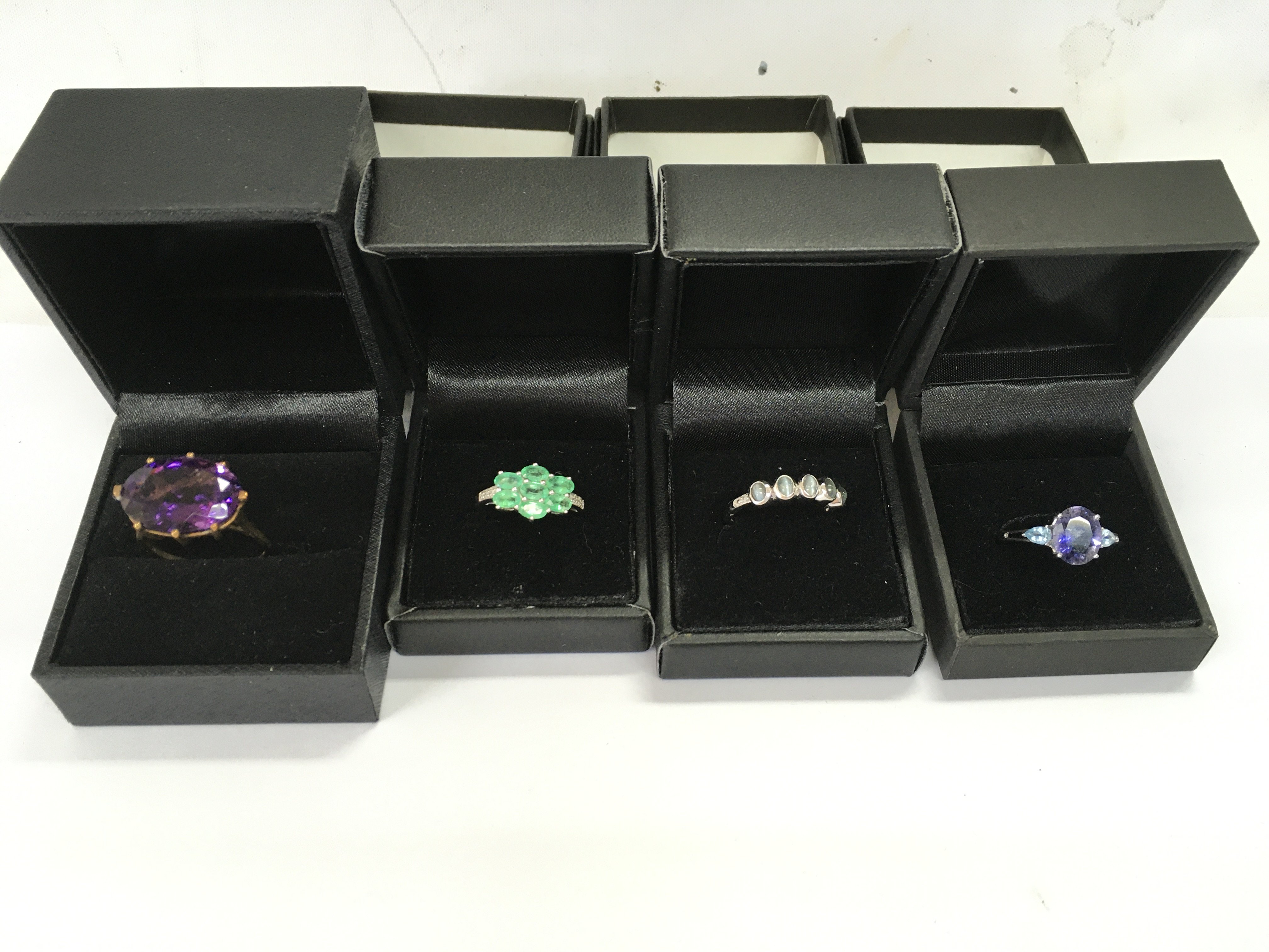 A collection of four 9ct gold rings set with various stones. 12.43g total Postage B