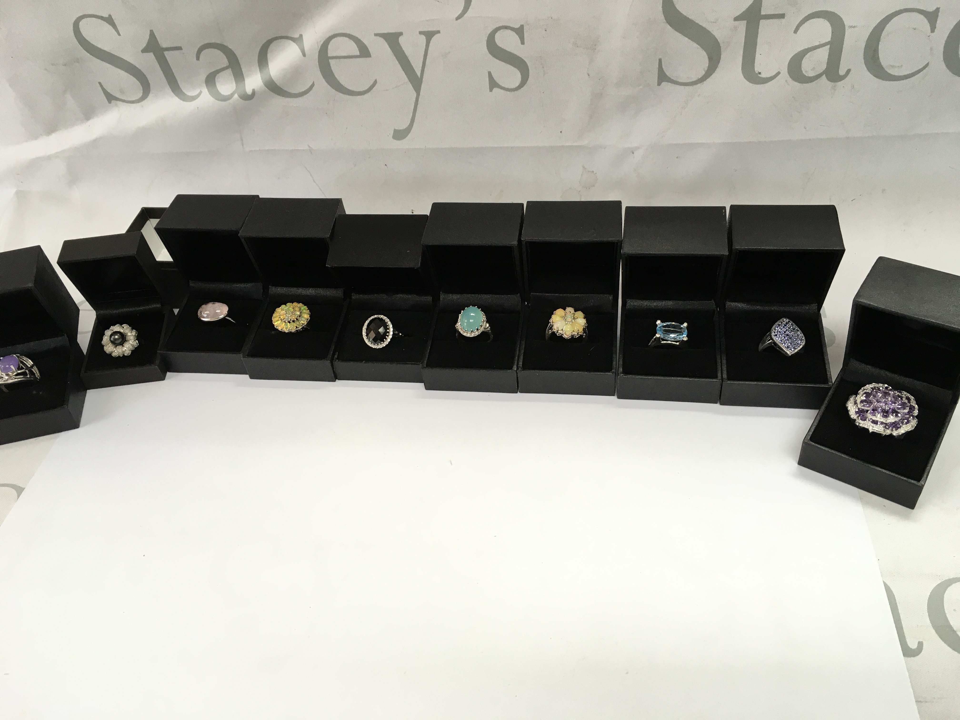 A collection of 10 assorted silver rings set with various stones. Postage B