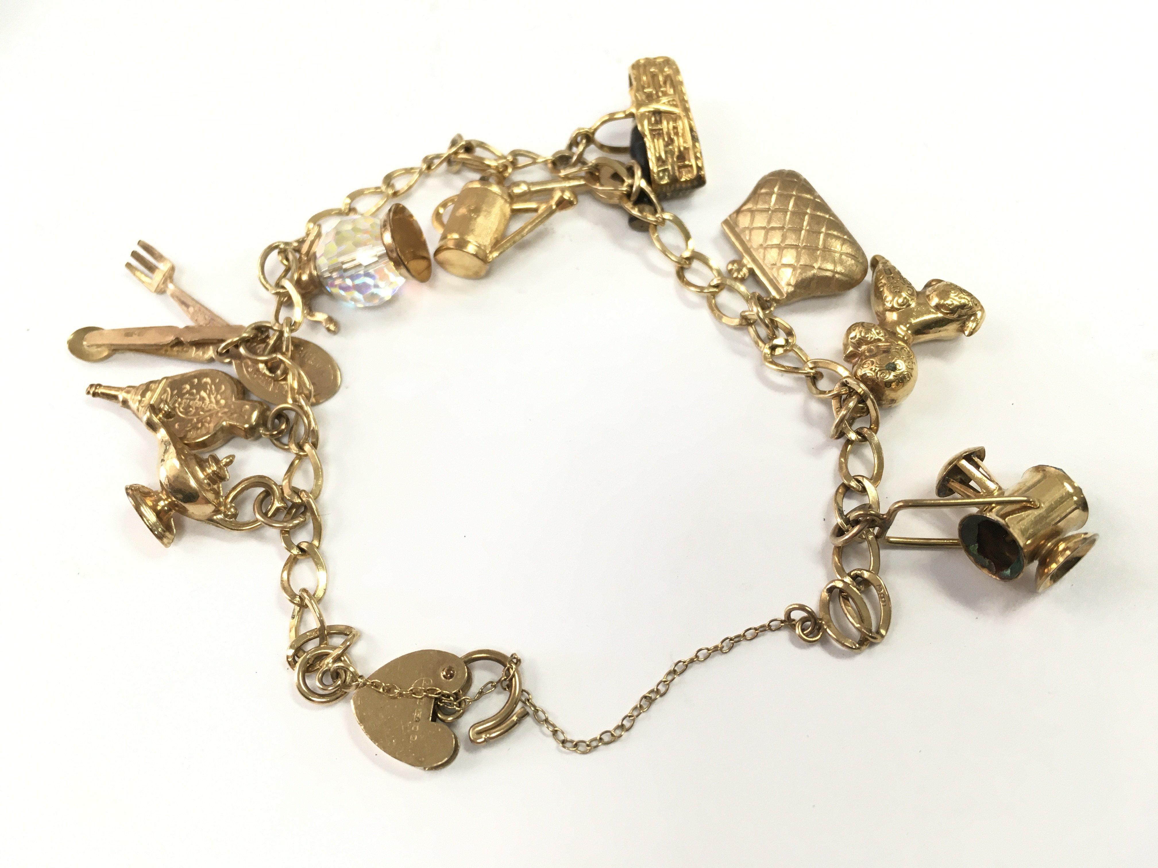 A 9ct gold charm bracelet, total weight 16.4g. Postage category A