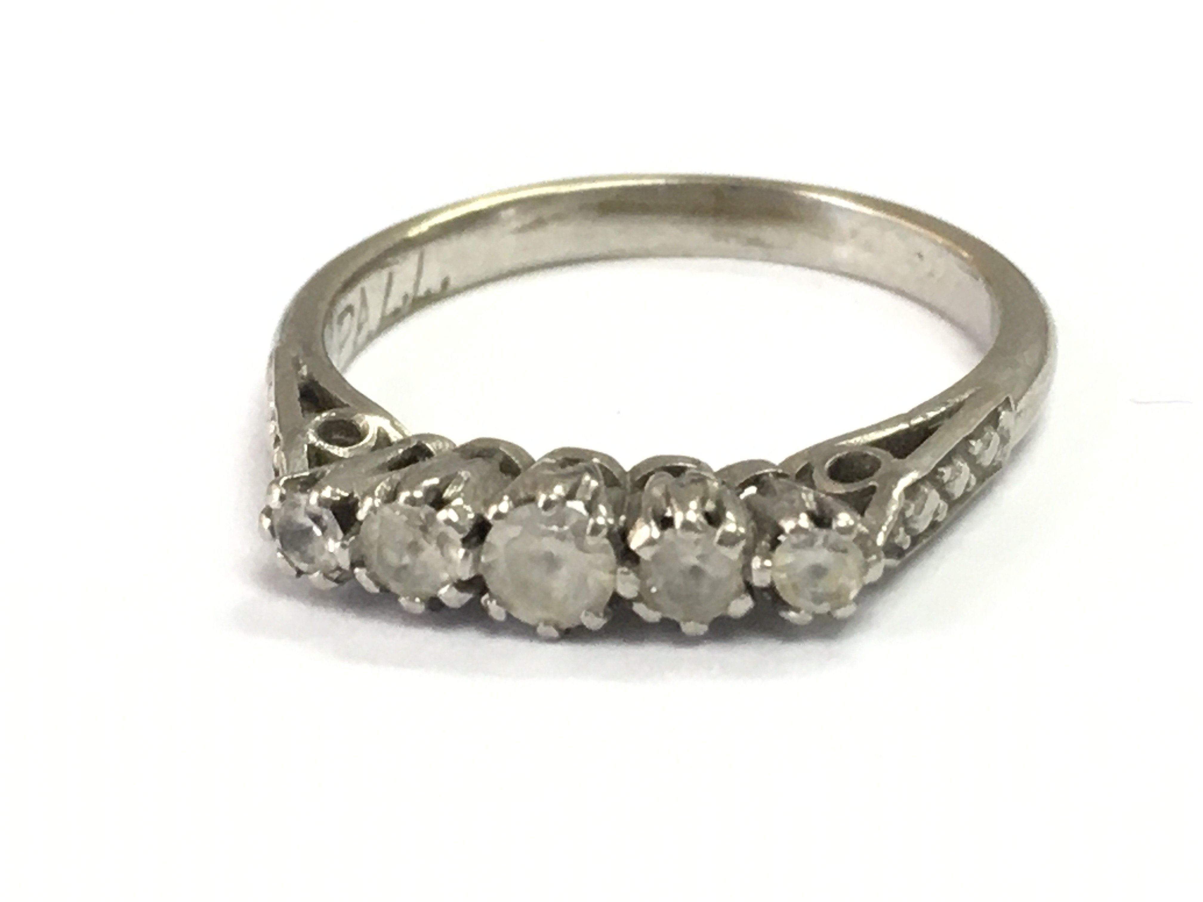 A Palladium 5 stone ring ,size K. Postage category A