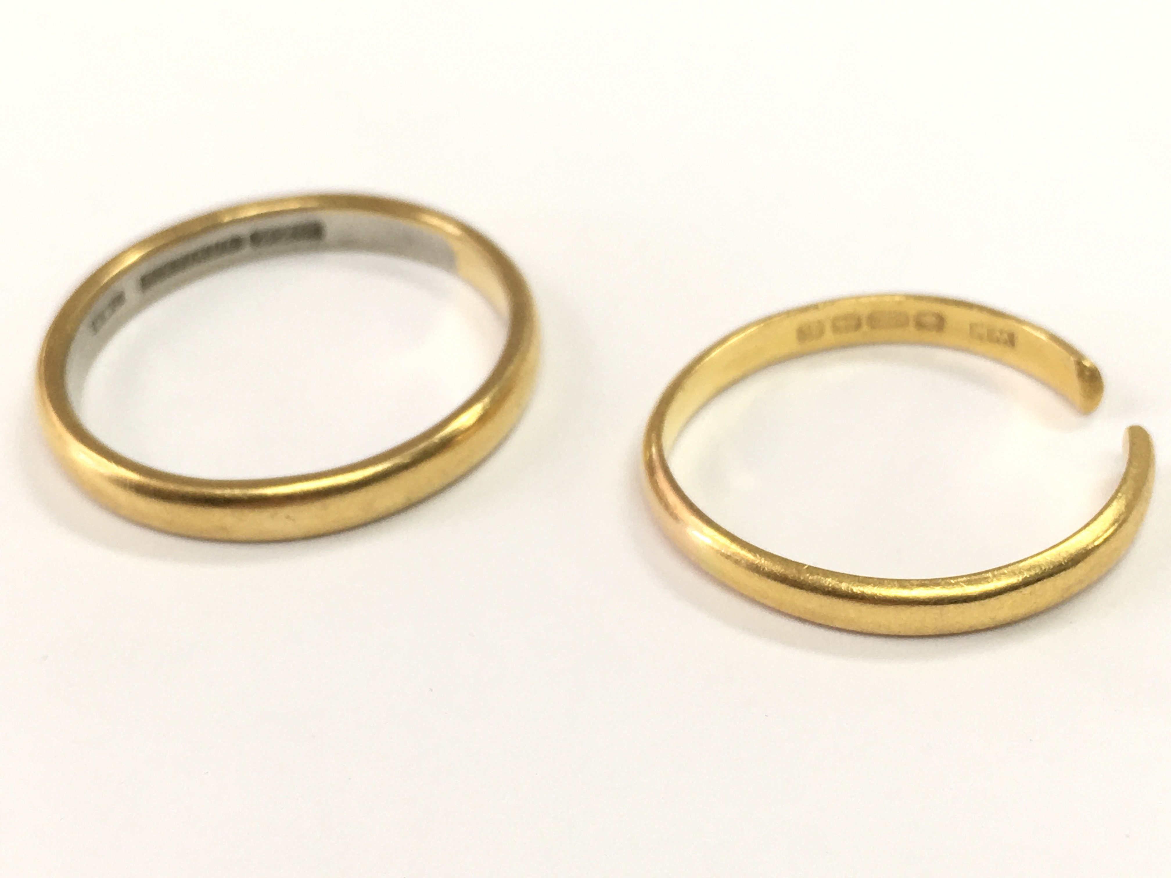 Two 22ct gold wedding band rings, 7.7g total weight. Size Q and T. postage category A