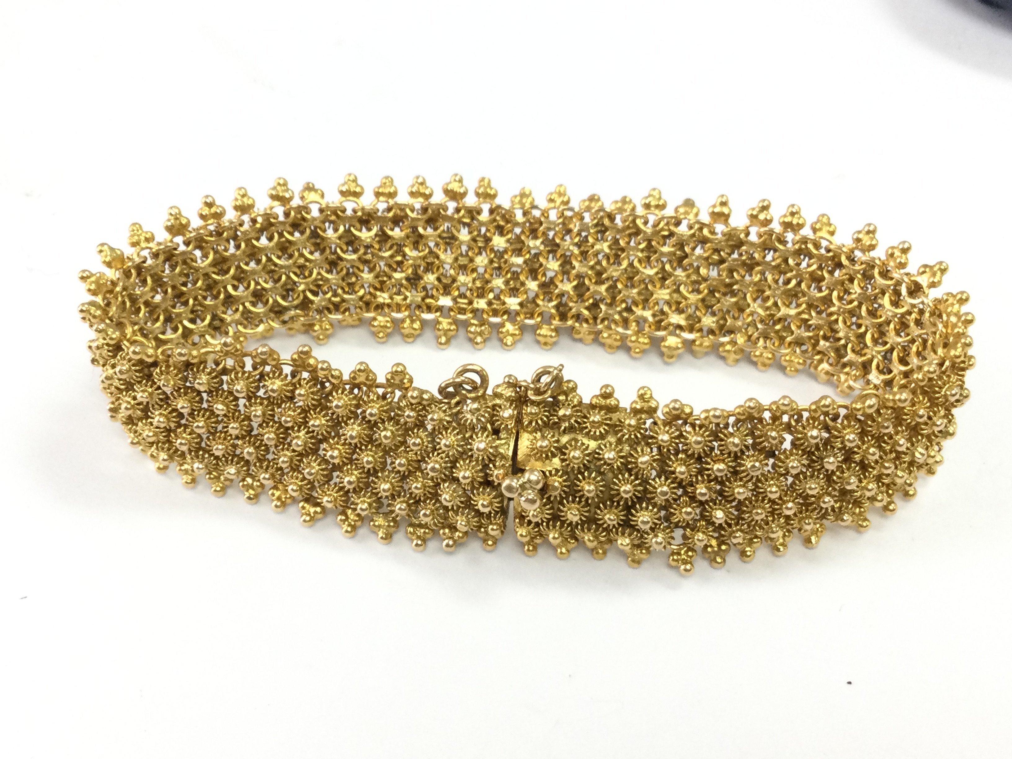 A 14ct gold bracelet , 28.6g total weight. Postage category A
