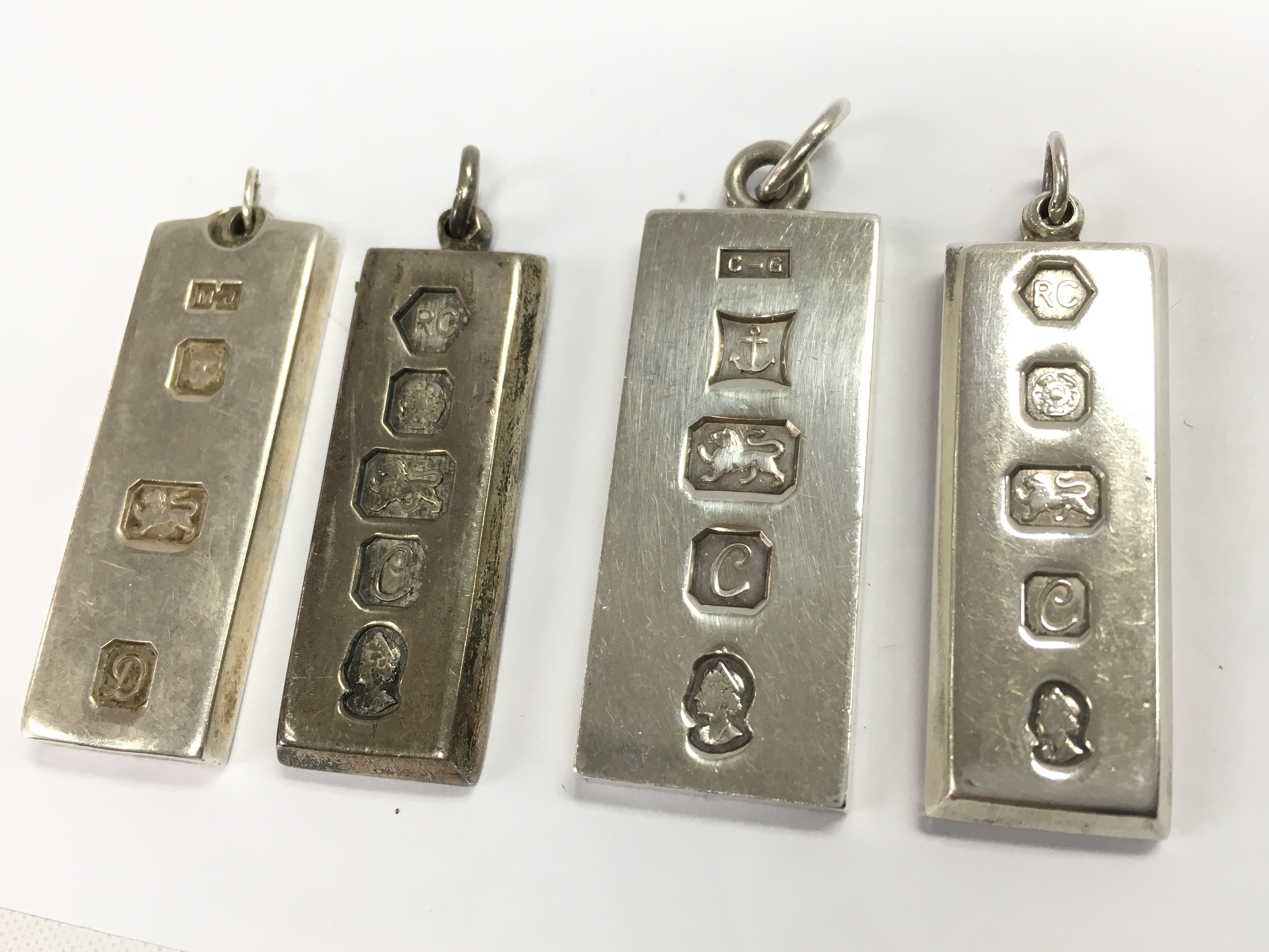 Four solid silver hallmarked ingot pendants , 120g total weight. Postage category A