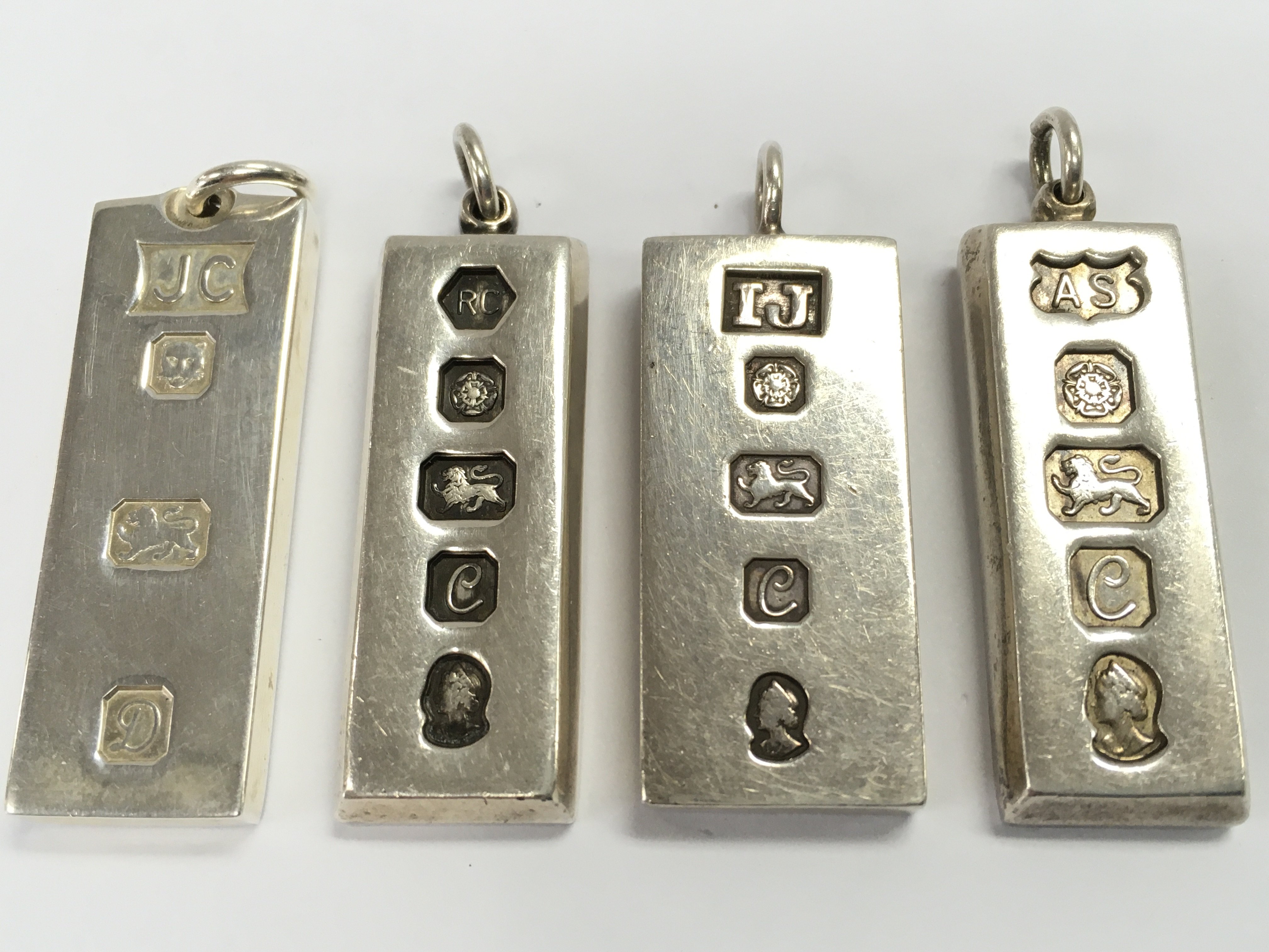 Four silver hallmarked ingot pendants , 120g total weight. Postage cat A