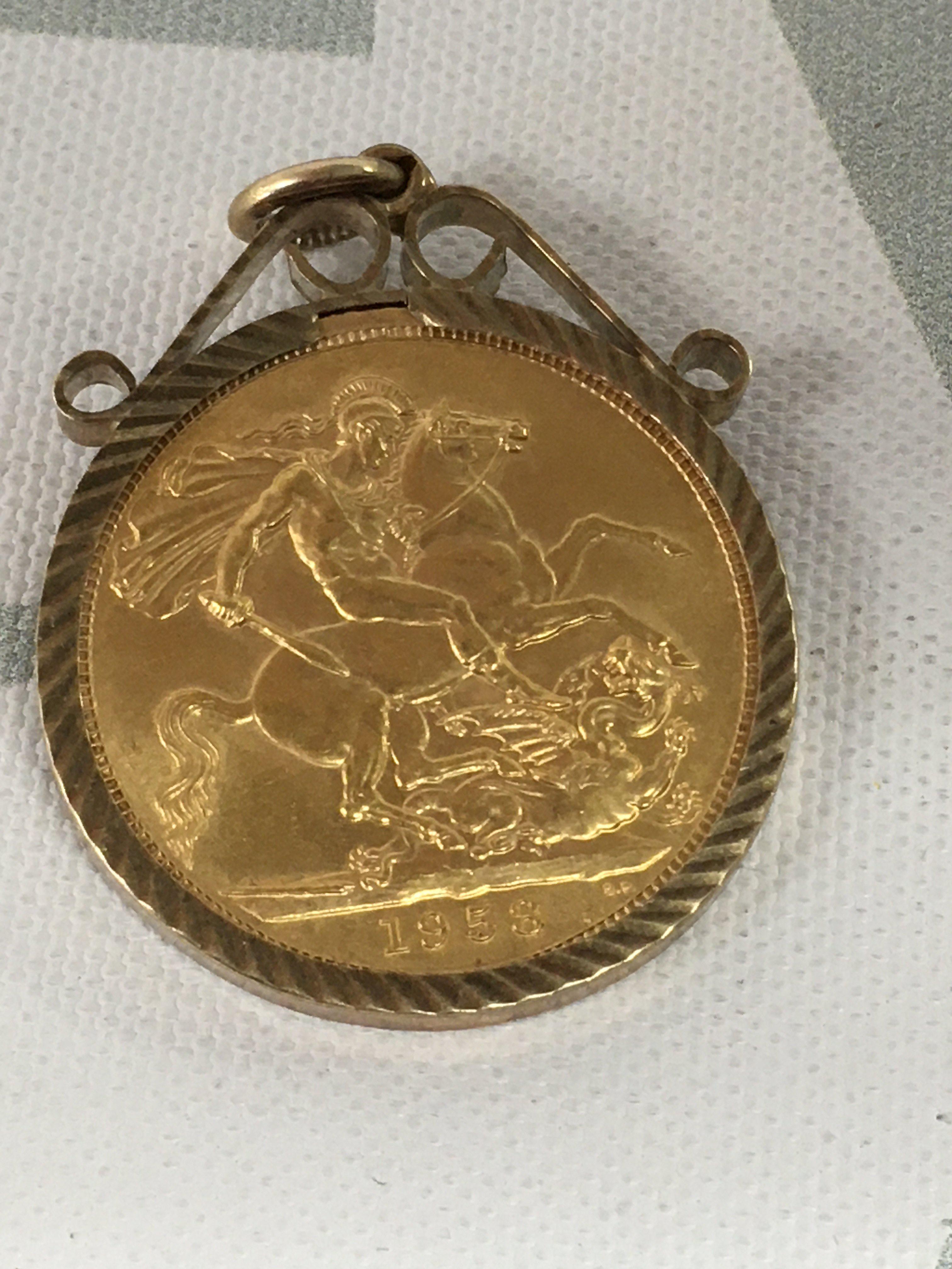 A gold 1958 full sovereign in mount .