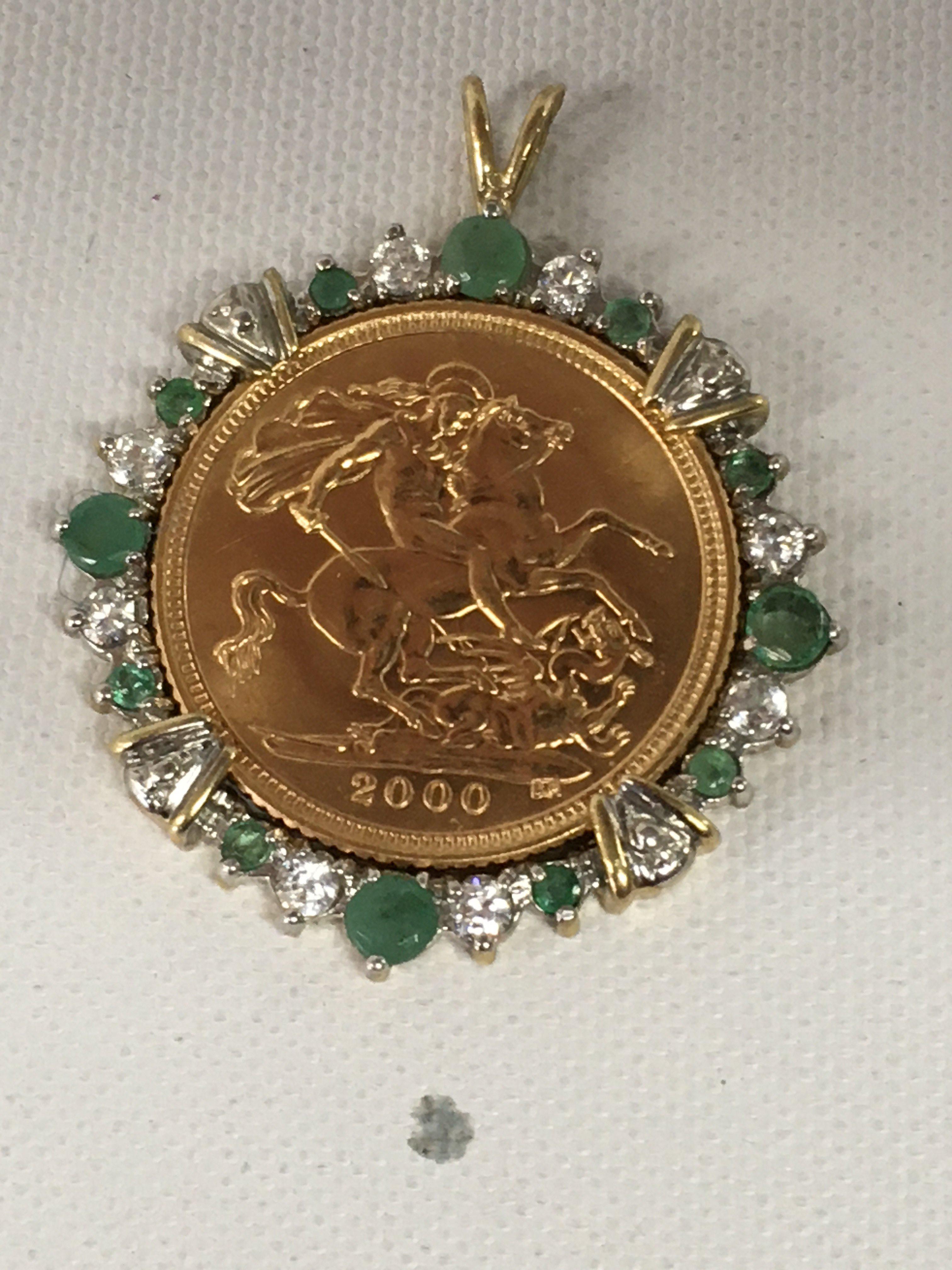 A 2000 half sovereign fitted in a mounted pendant.