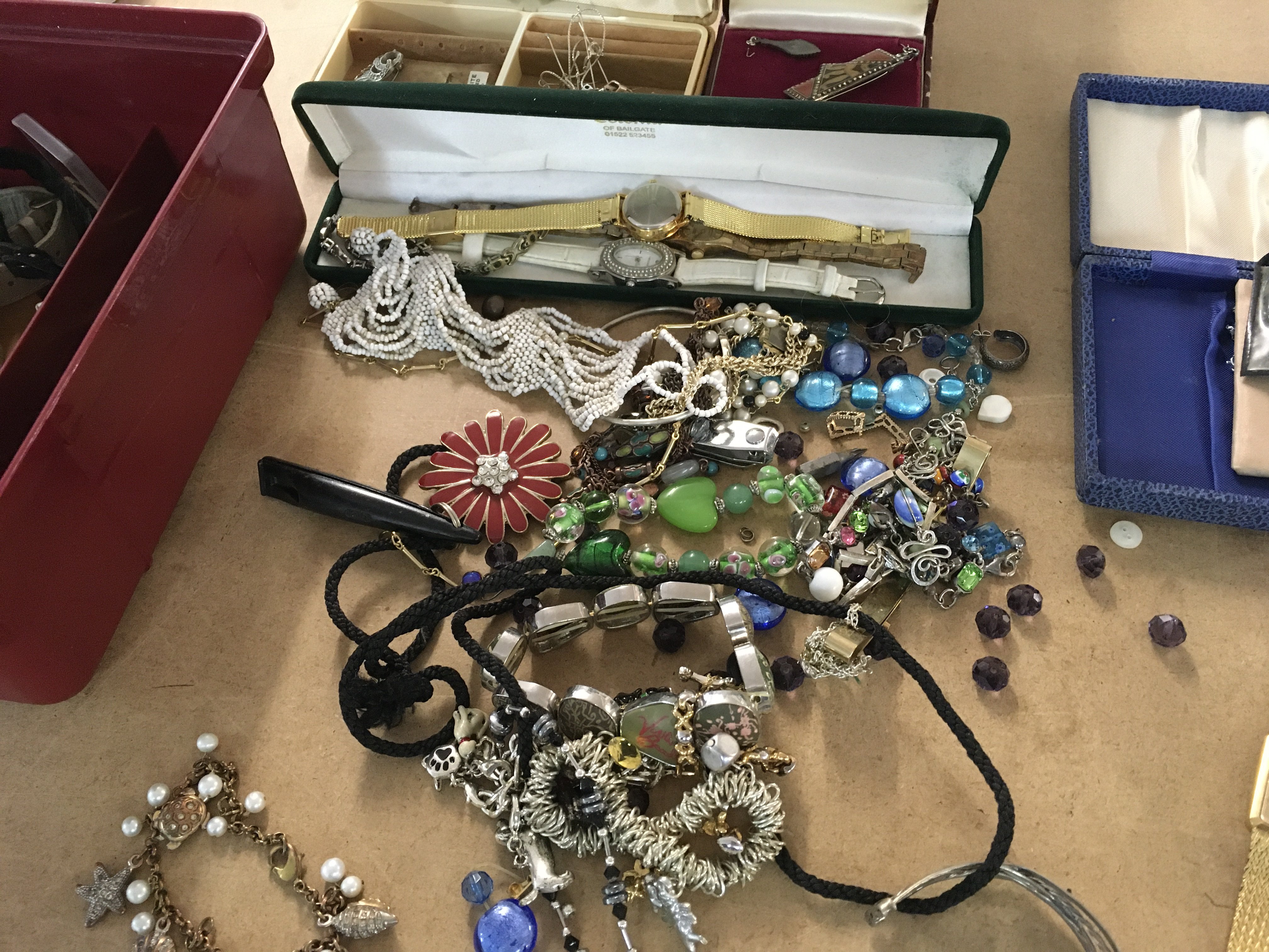 A collection of costume jewellery dress watches and a small collection of coins .