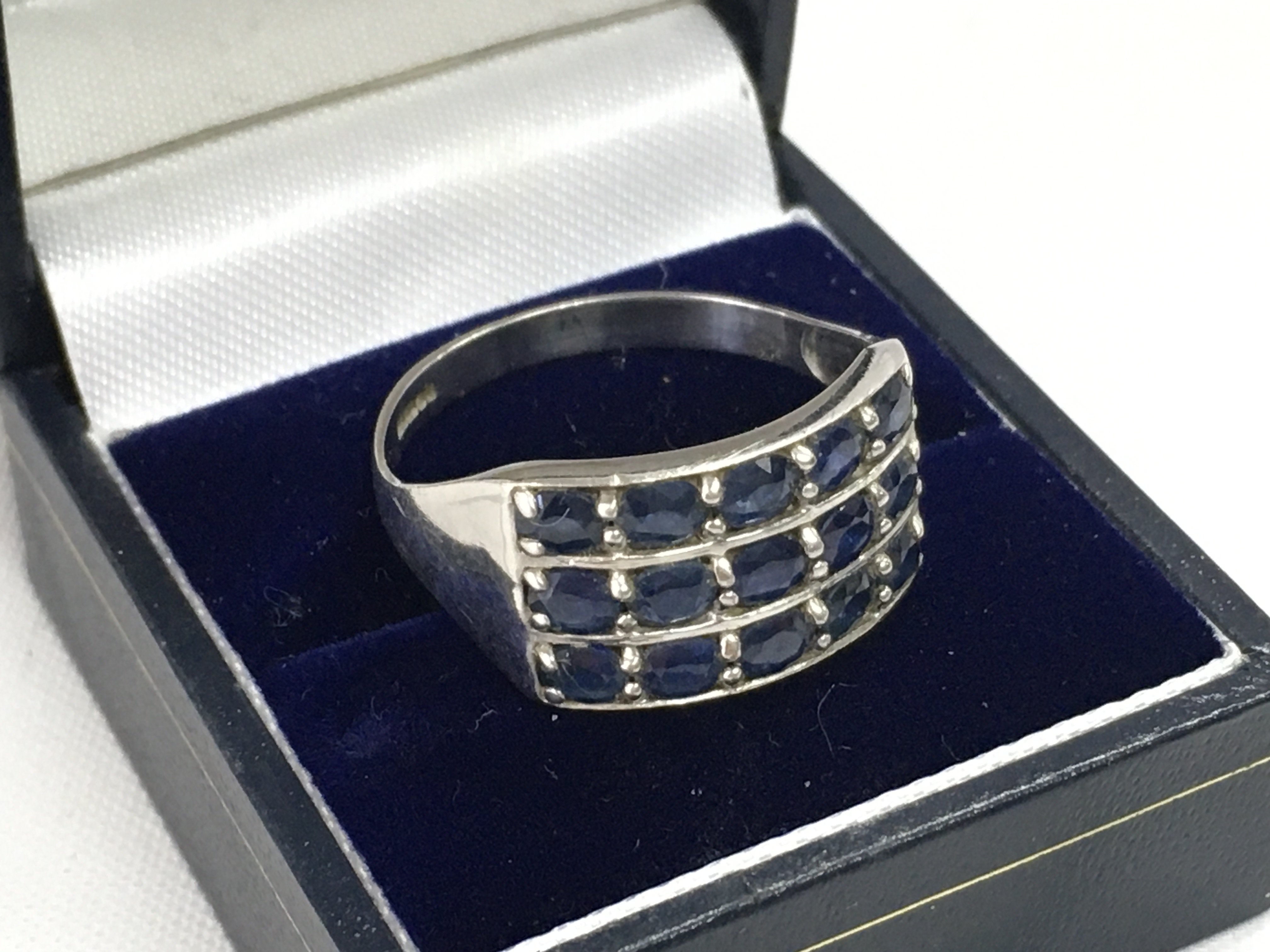 A 9ct white gold ring set with blue sapphire stones, size Z. Total weight 4.5g. Postage category A