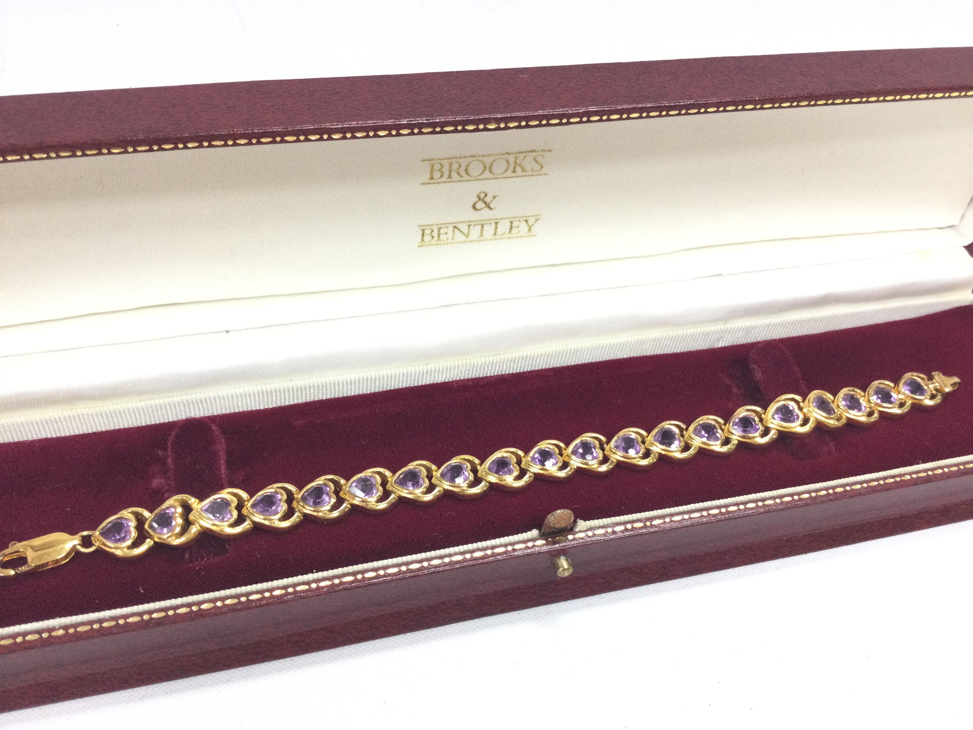 A silver gilt Amethyst heart bracelet. Postage category A