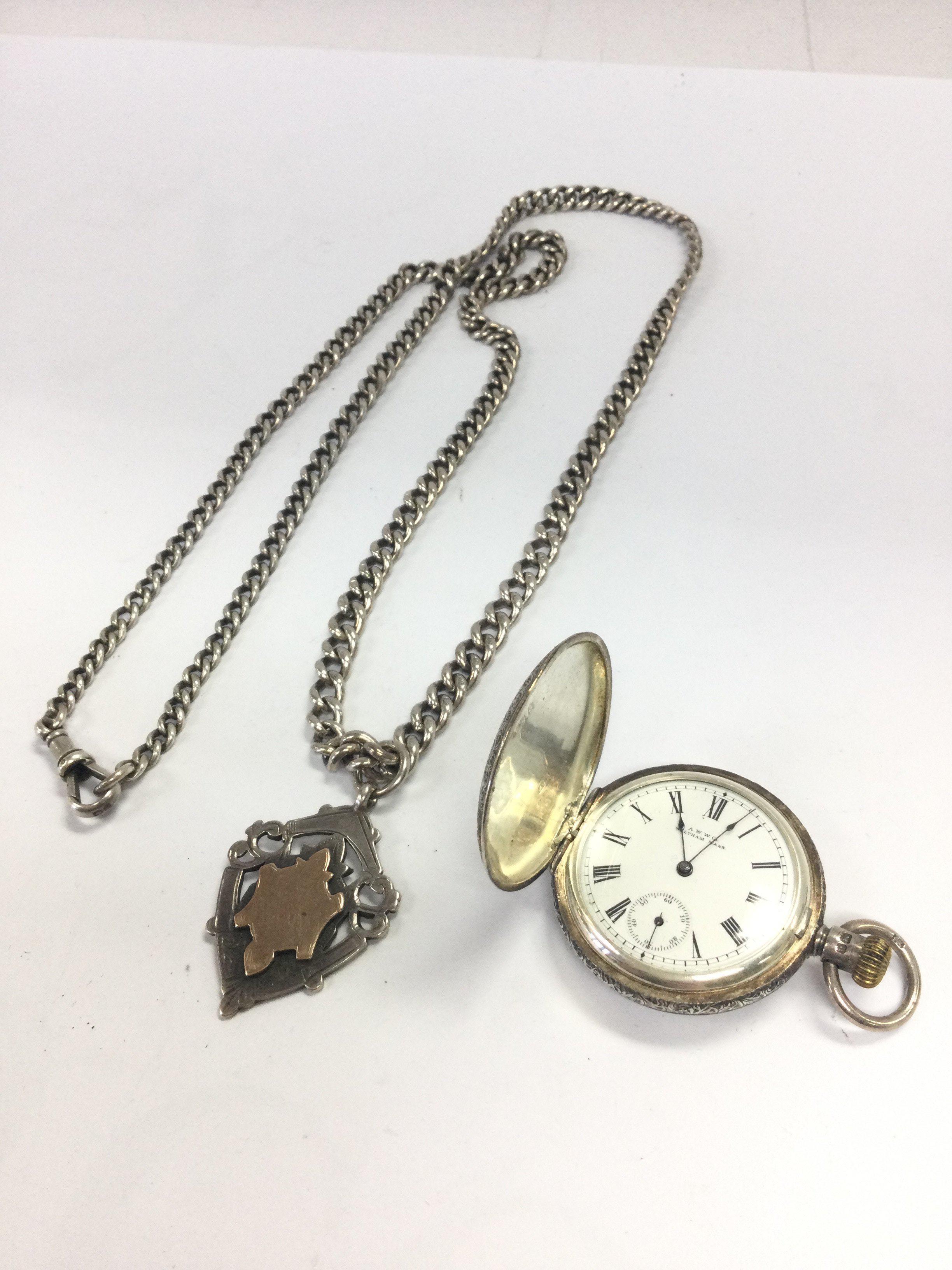 A silver hallmarked cased A.W.W Co Waltham Ladies fob watch ( seen working ) and a silver hallmarked Albert chain. Postage category A