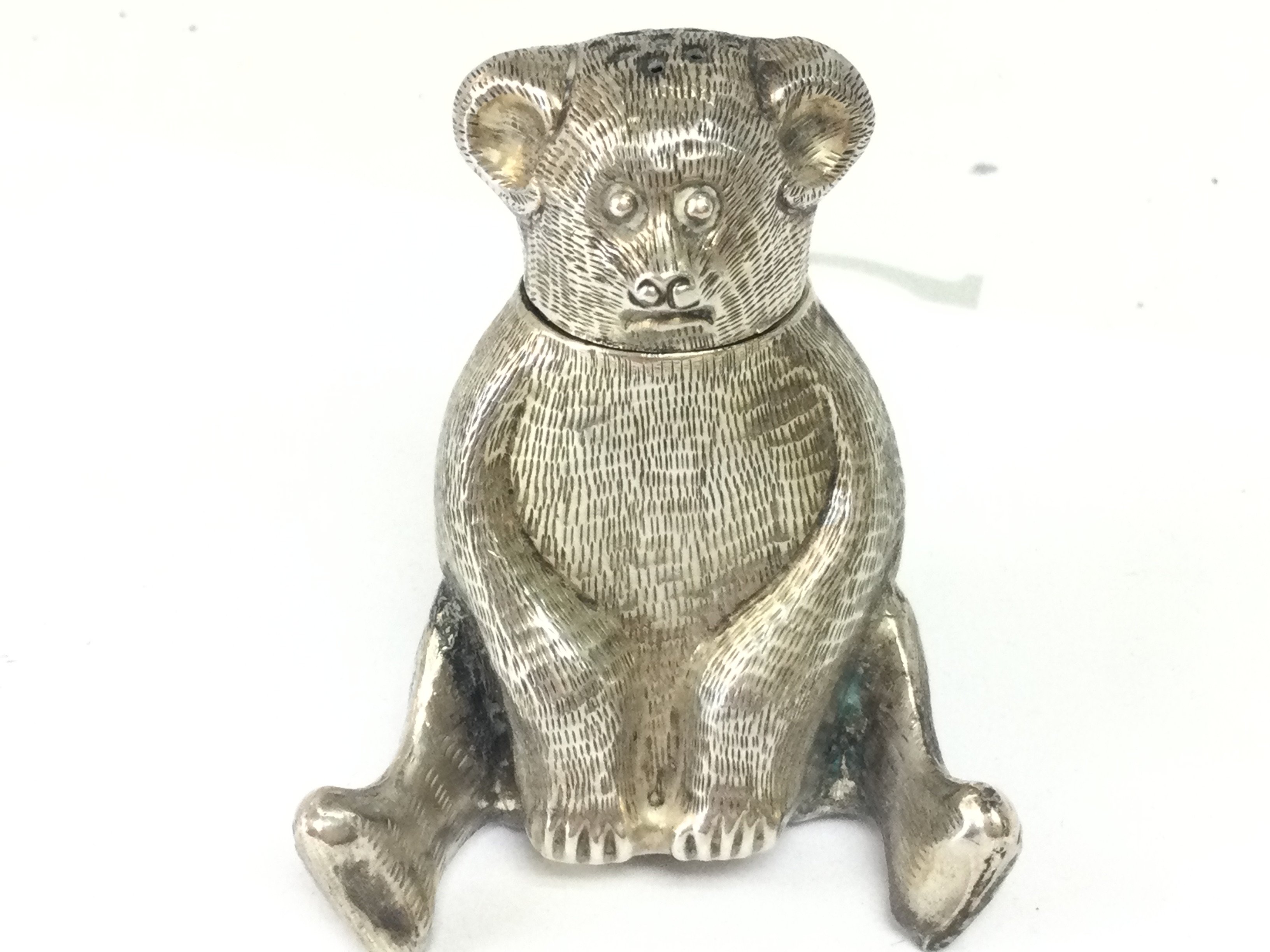 A Victorian novelty silver plated bear pepperette , 5cm tall. Postage category A