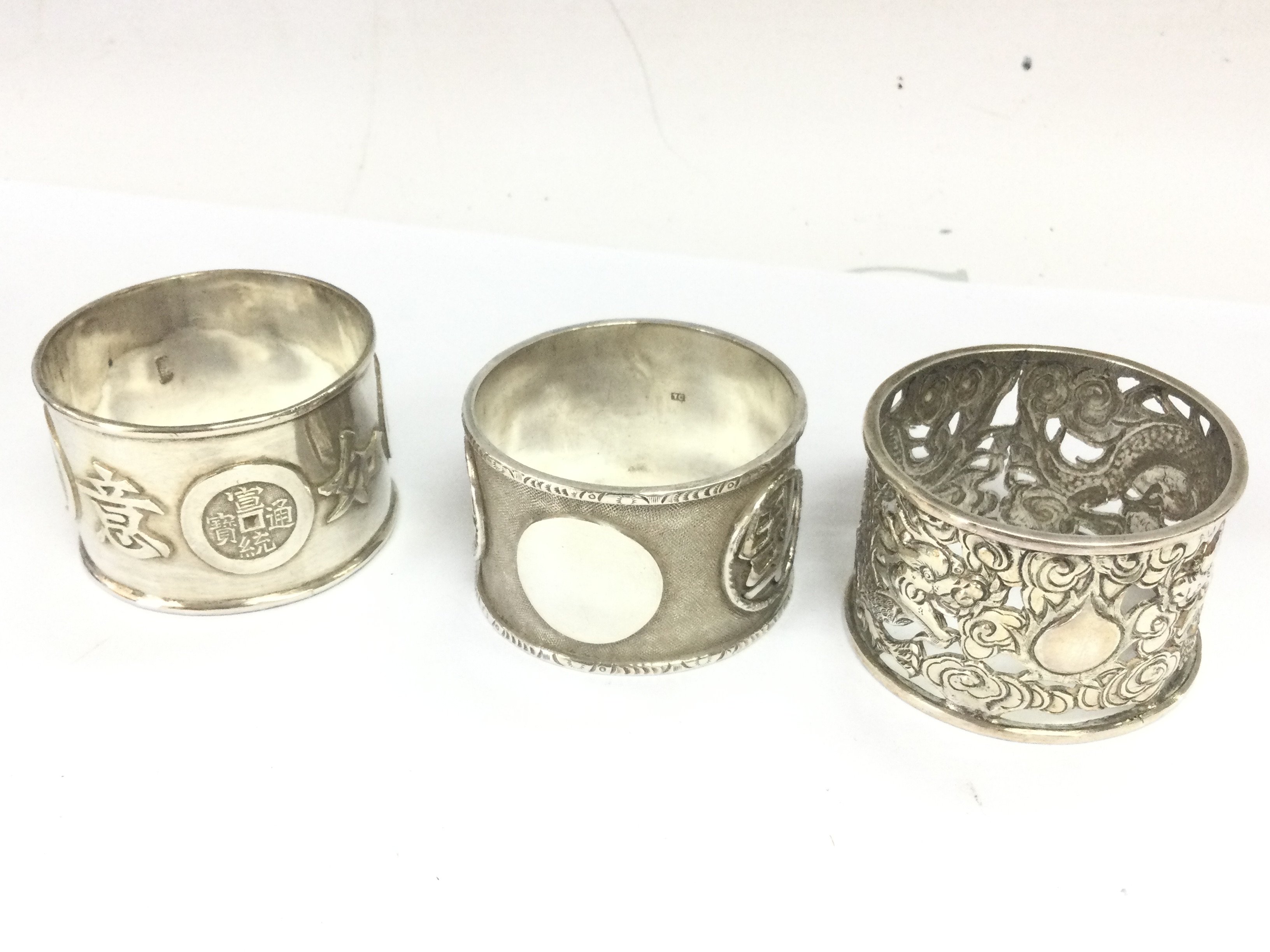 Three Chinese silver napkin rings . Postage category A