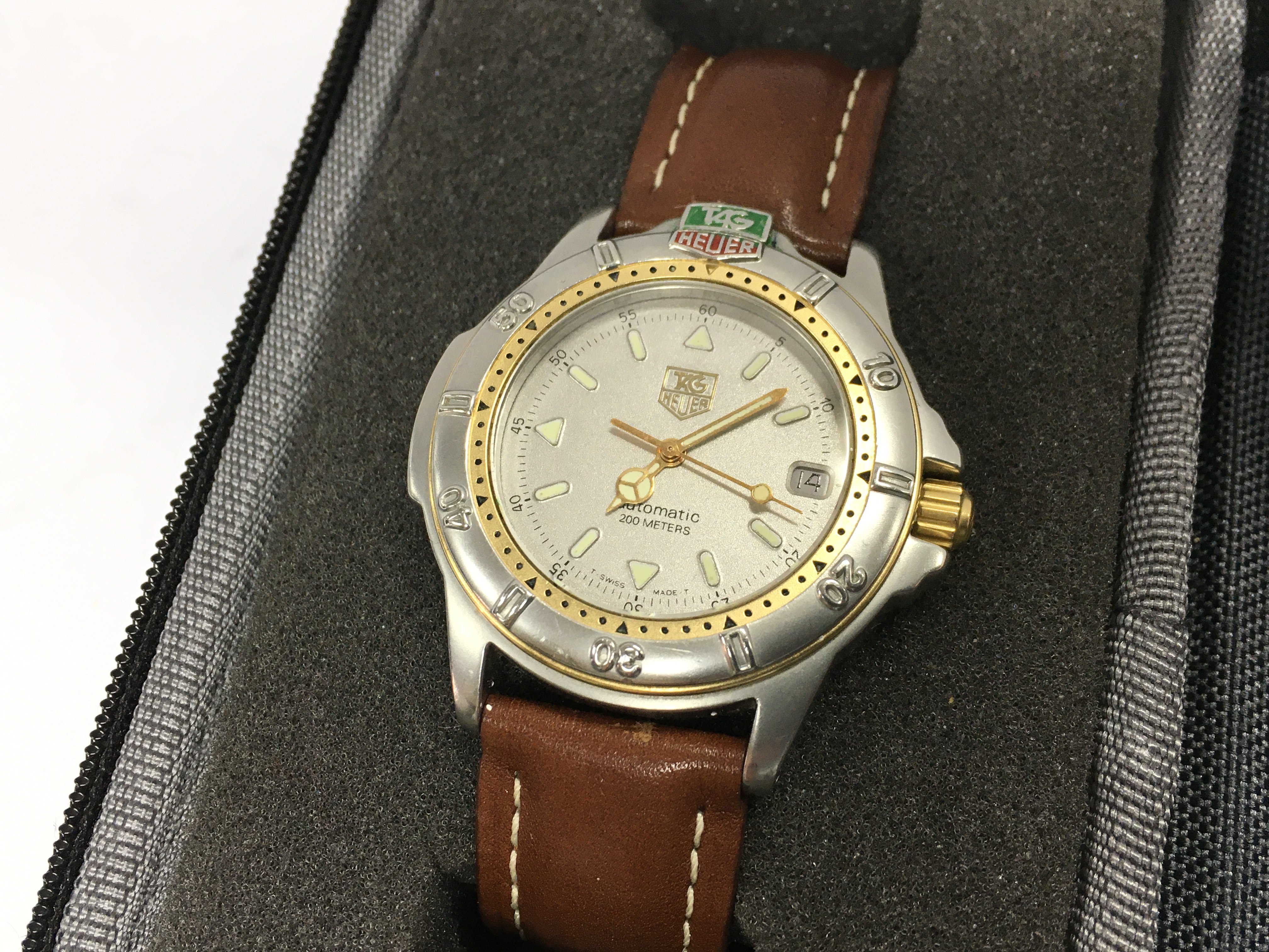 a Tag Heuer automatic 200 metres mens watch with a leather strap. Seen working Postage category A