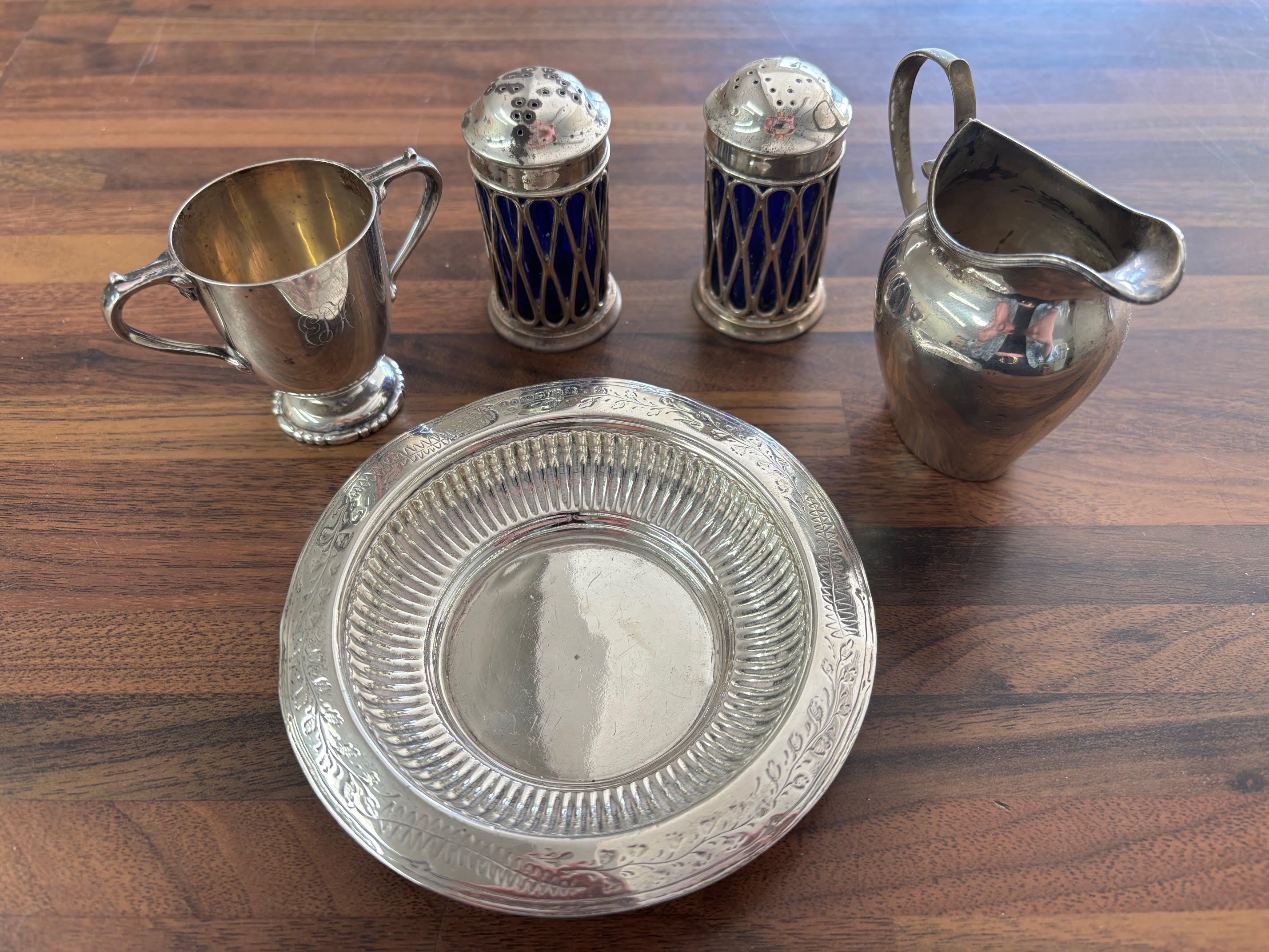 A collection of silver items comprising cruets, jug, etc. Shipping category B.