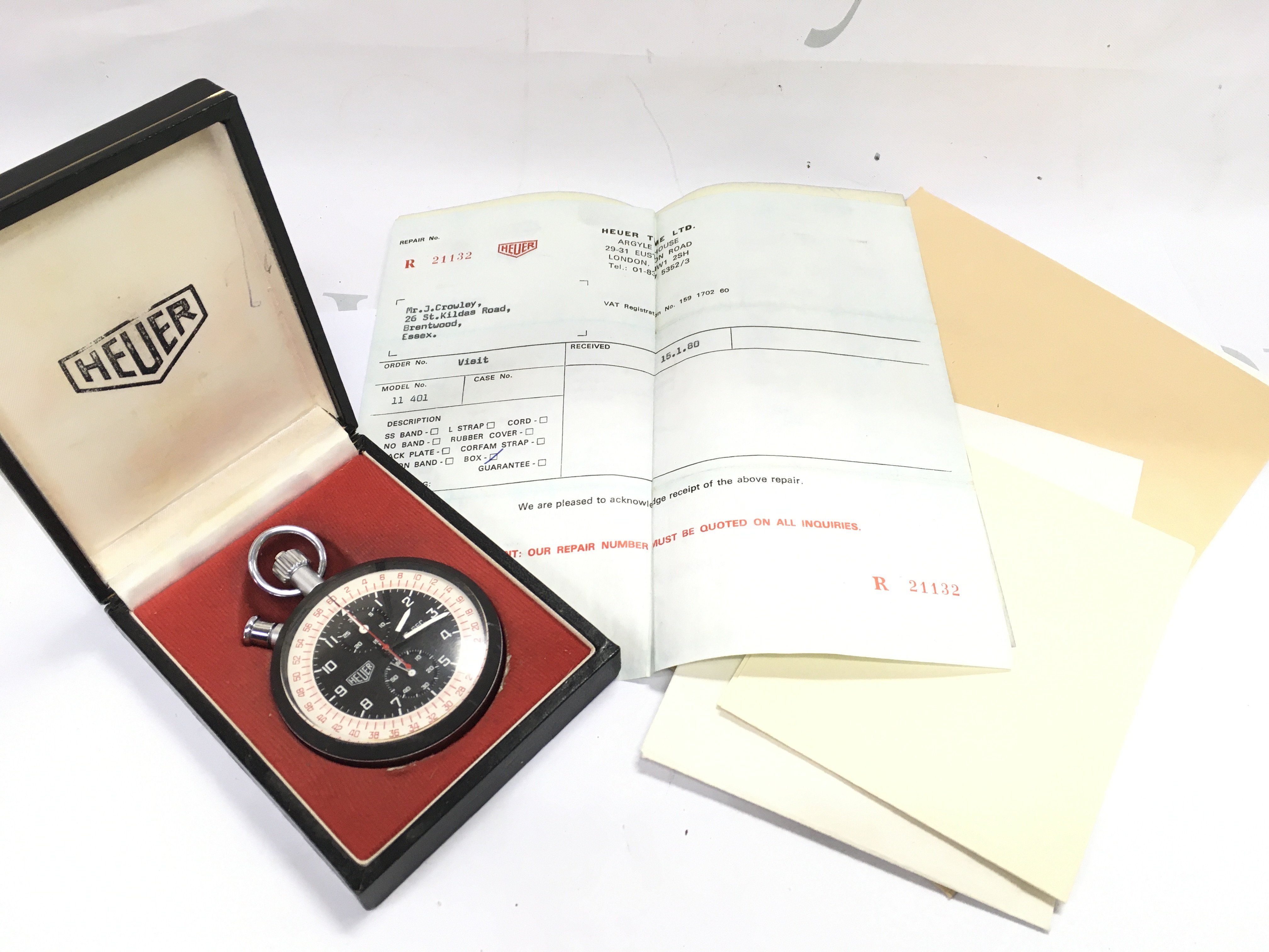 A cased vintage Heuer trackmaster stop watch with papers, seen working. Postage category A