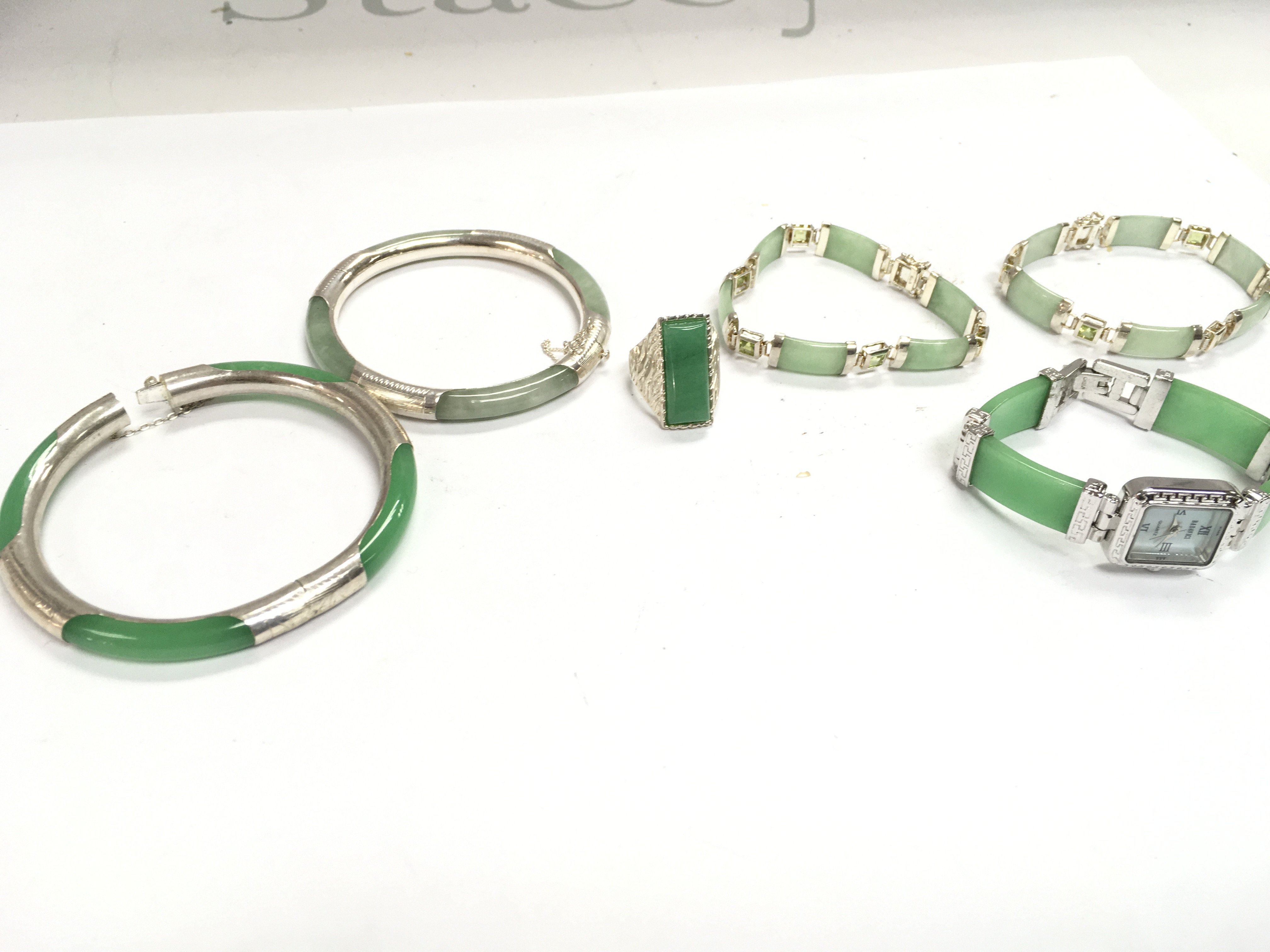 A mixed collection of silver and jade jewellery including bracelets, ring and a watch. Postage category A