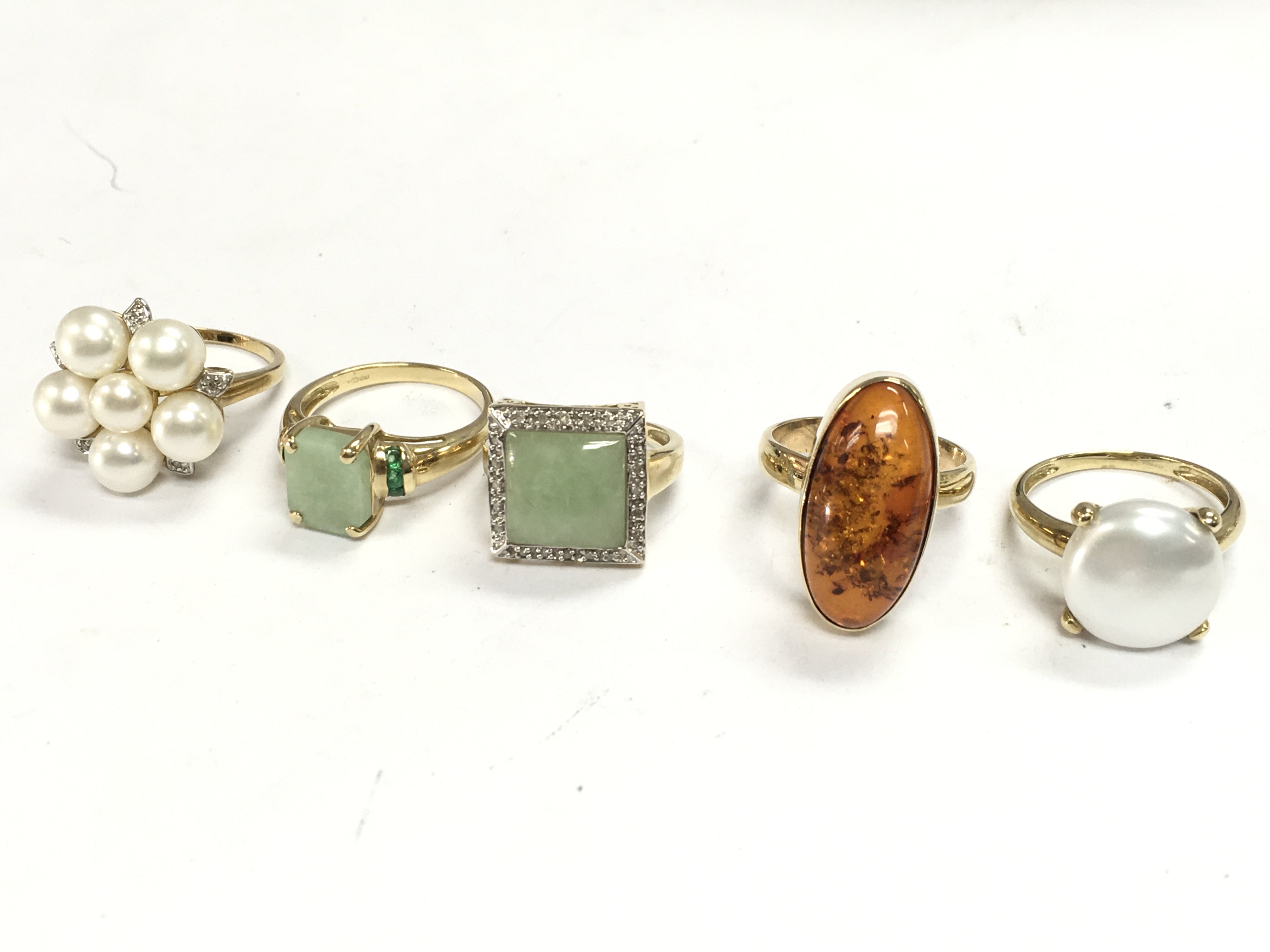 Five 9 carat gold rings set with various stones