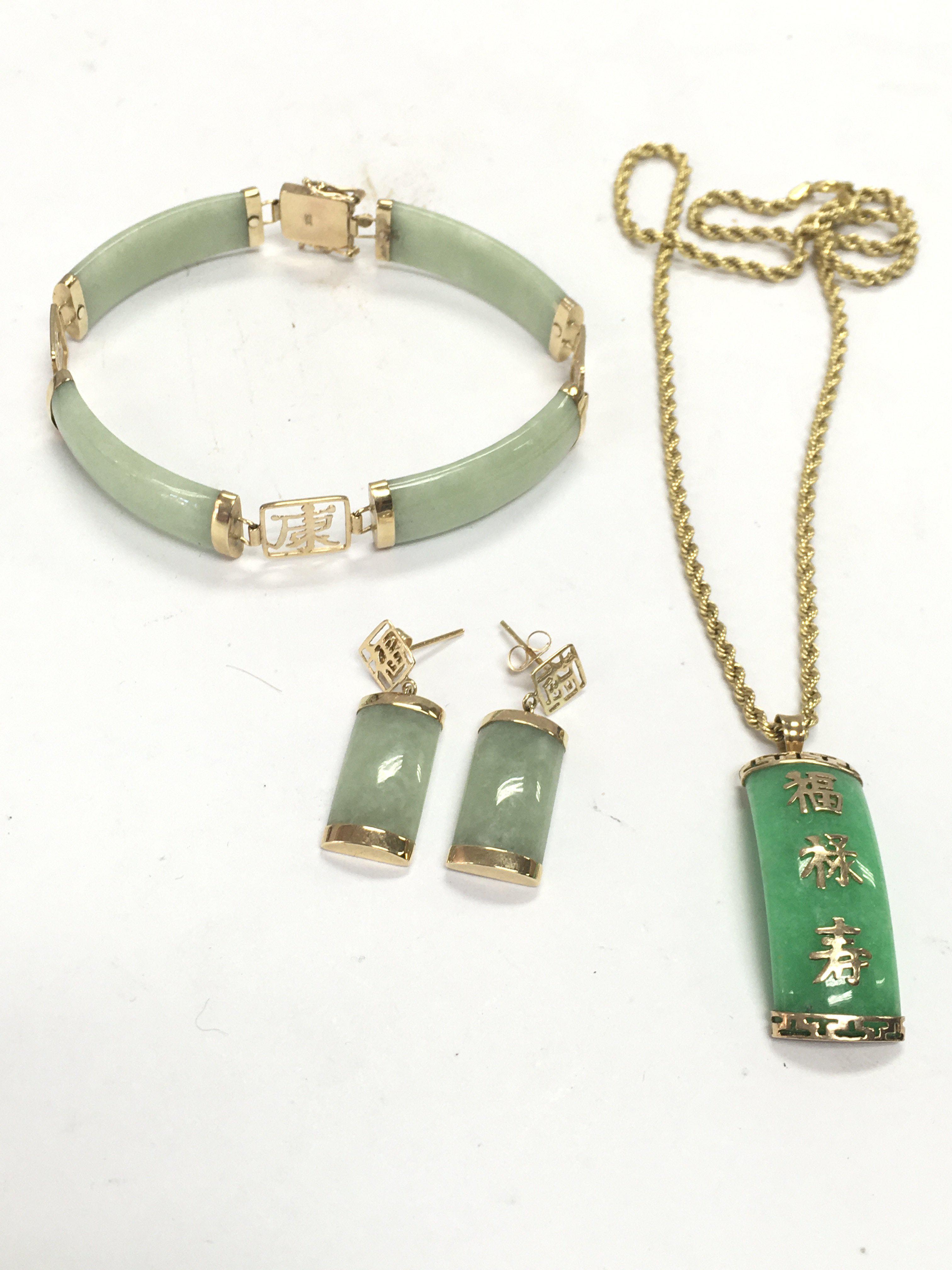 A collection of 9ct gold and jade jewellery including a Chinese bracelet, earrings , necklace with pendant. Postage category A