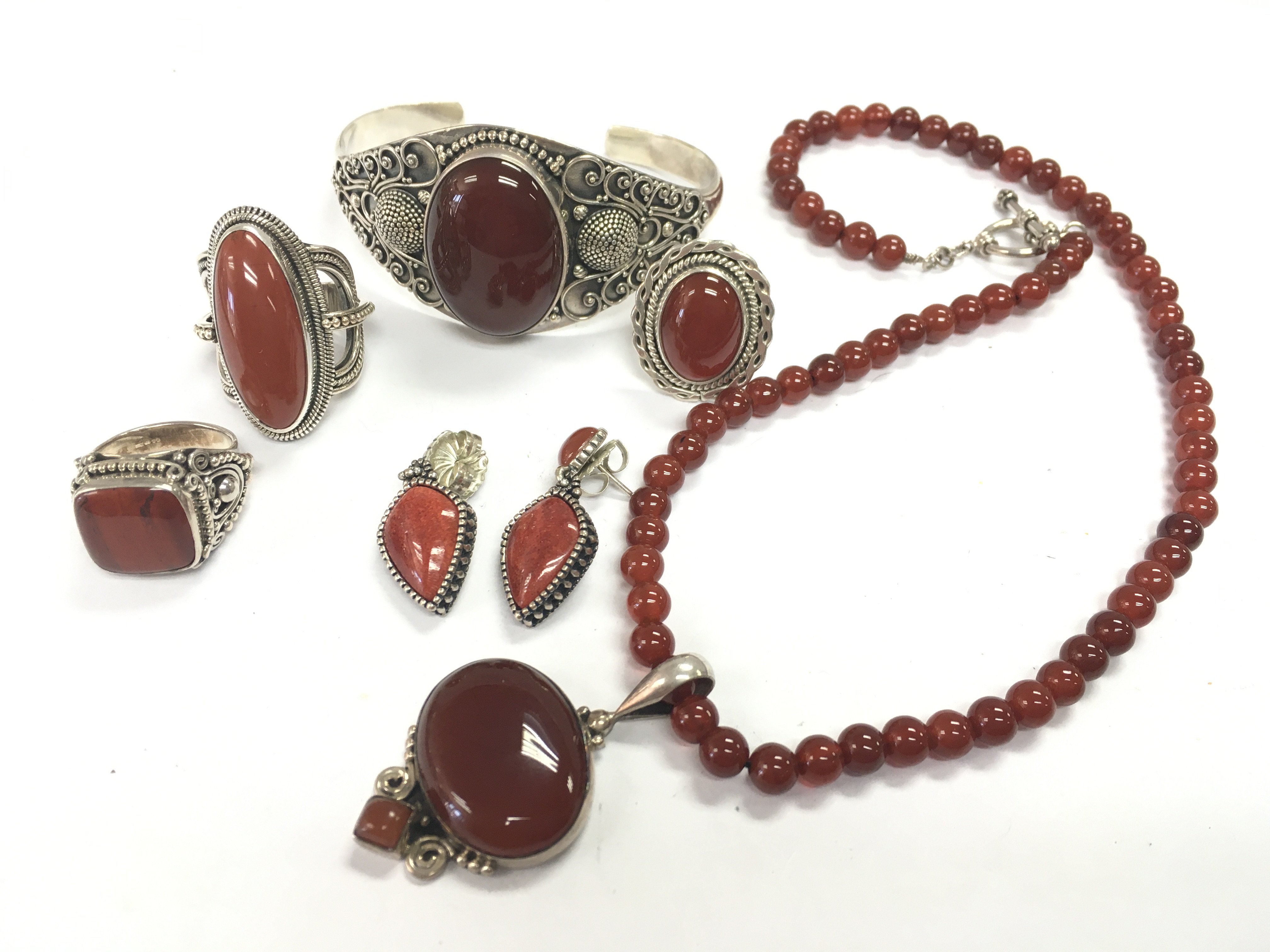 A collection of silver and Carnelian Marcasite Jewellery including rings, earrings, necklace etc. postage category b