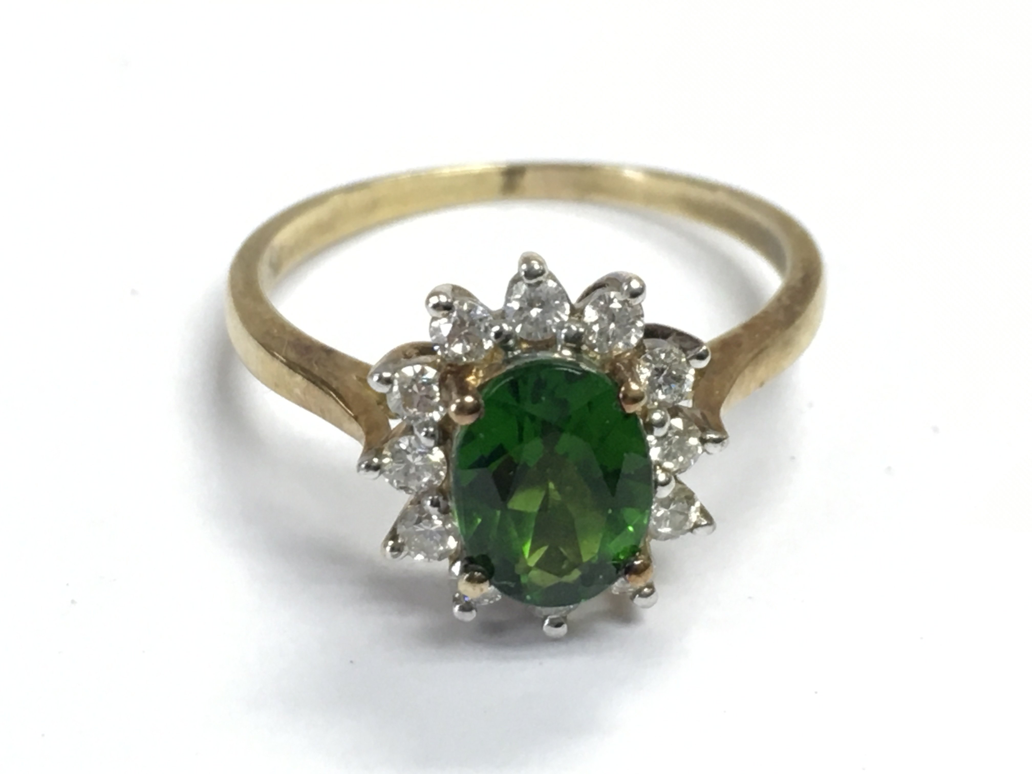 A 9 carat gold green cubic zirconia ring , size P, 2.7g postage category A