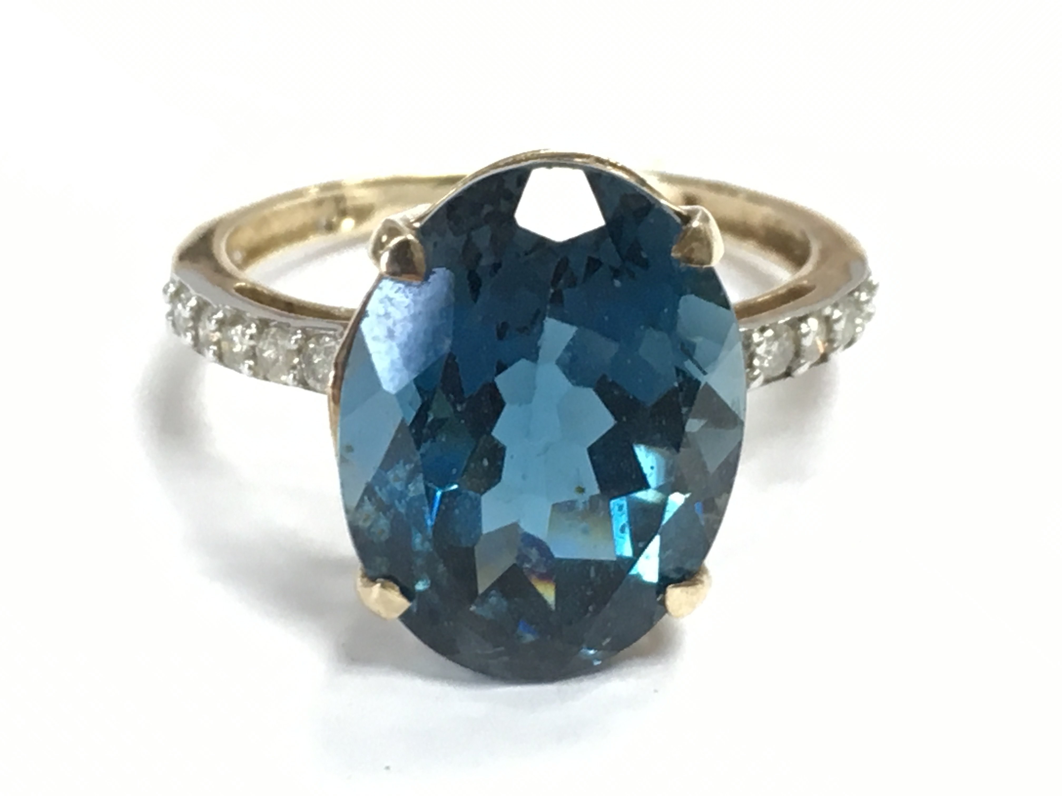 A 9 carat gold blue topaz stone and diamond set ring , 4.5g total weight. Size S. Postage category A