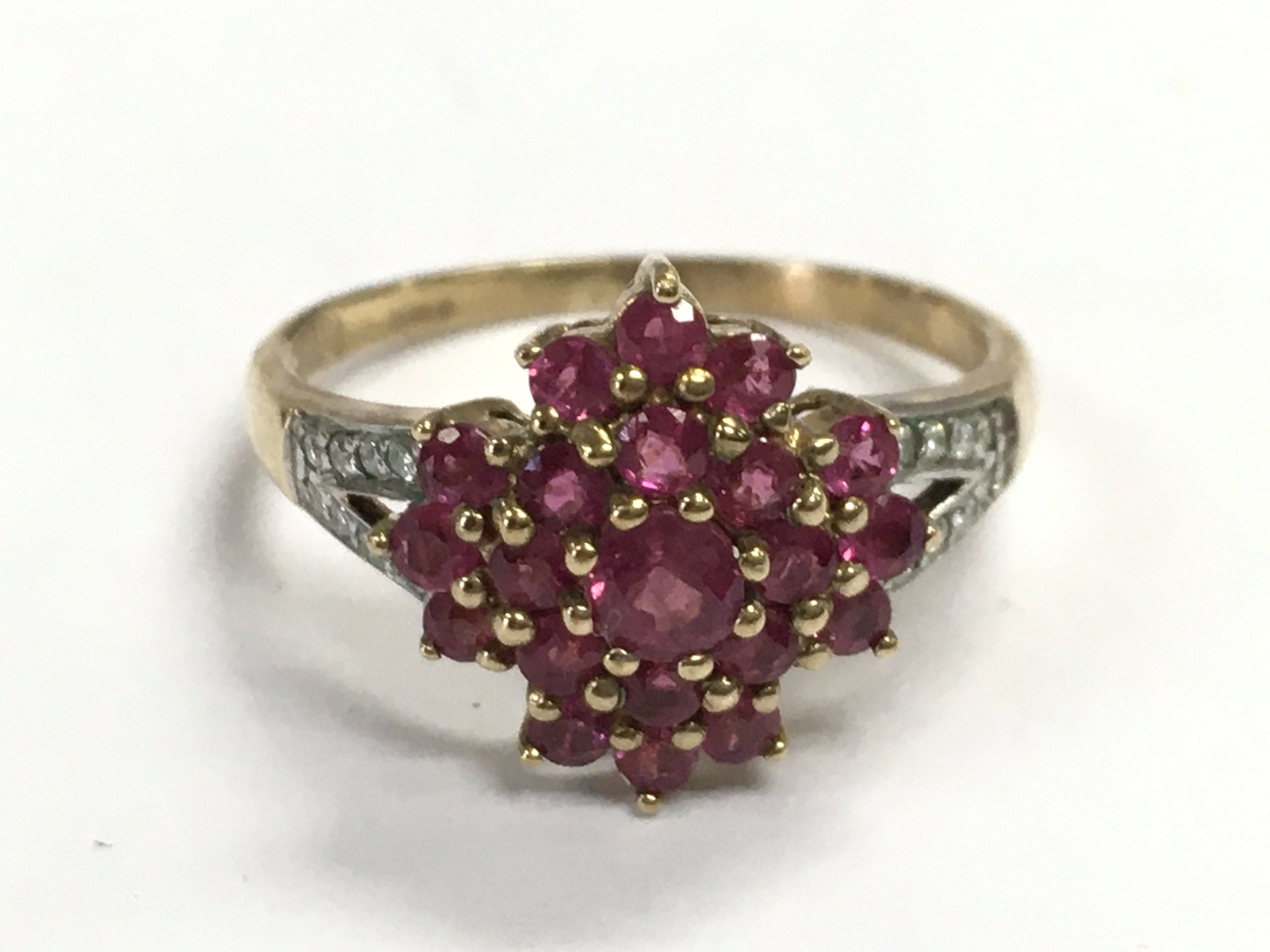 A 9 carat gold ruby and diamond set ring, size P. 2.8g Postage category A