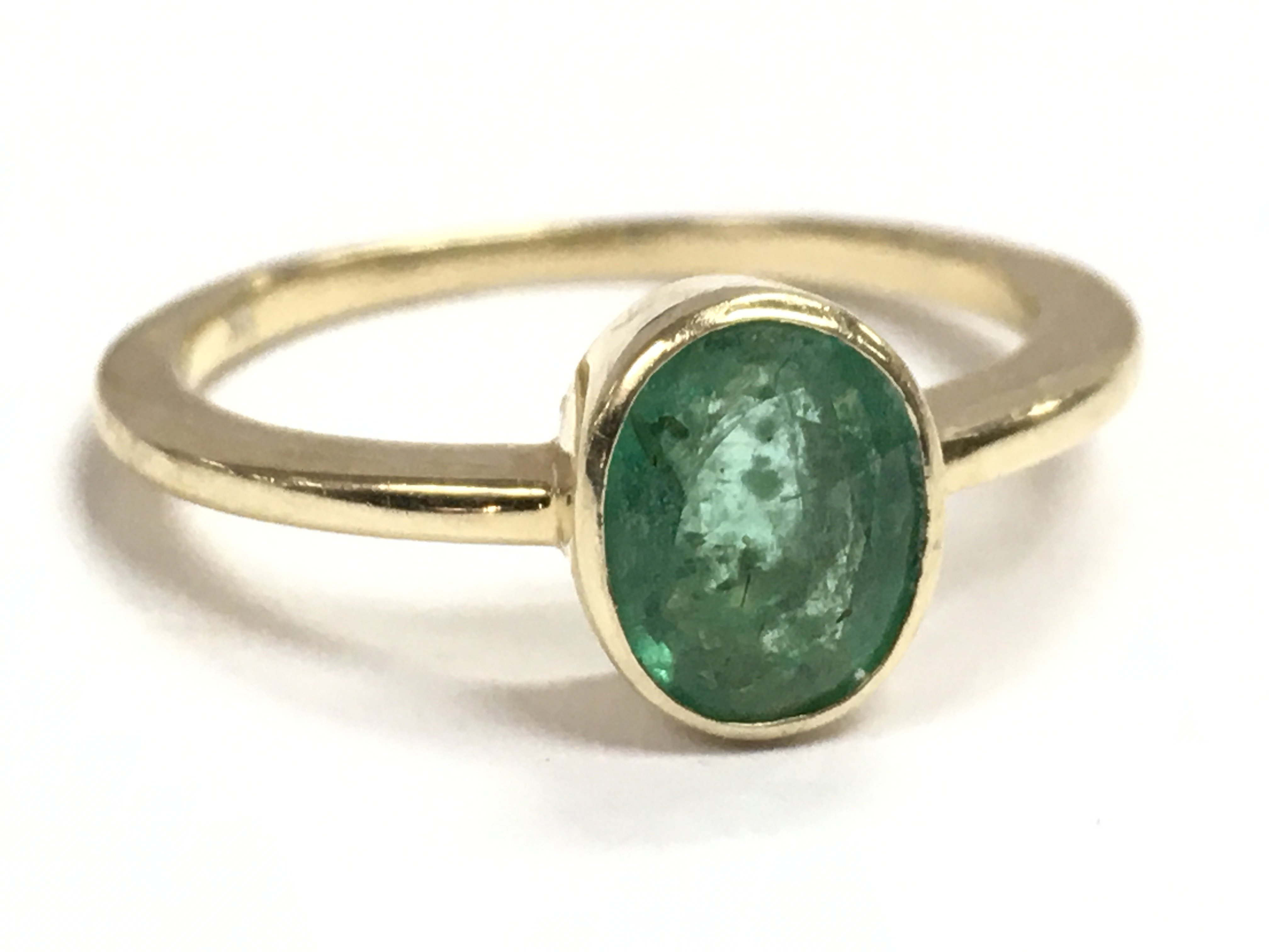 A 9 carat gold and emerald ring , 2.6g postage category A