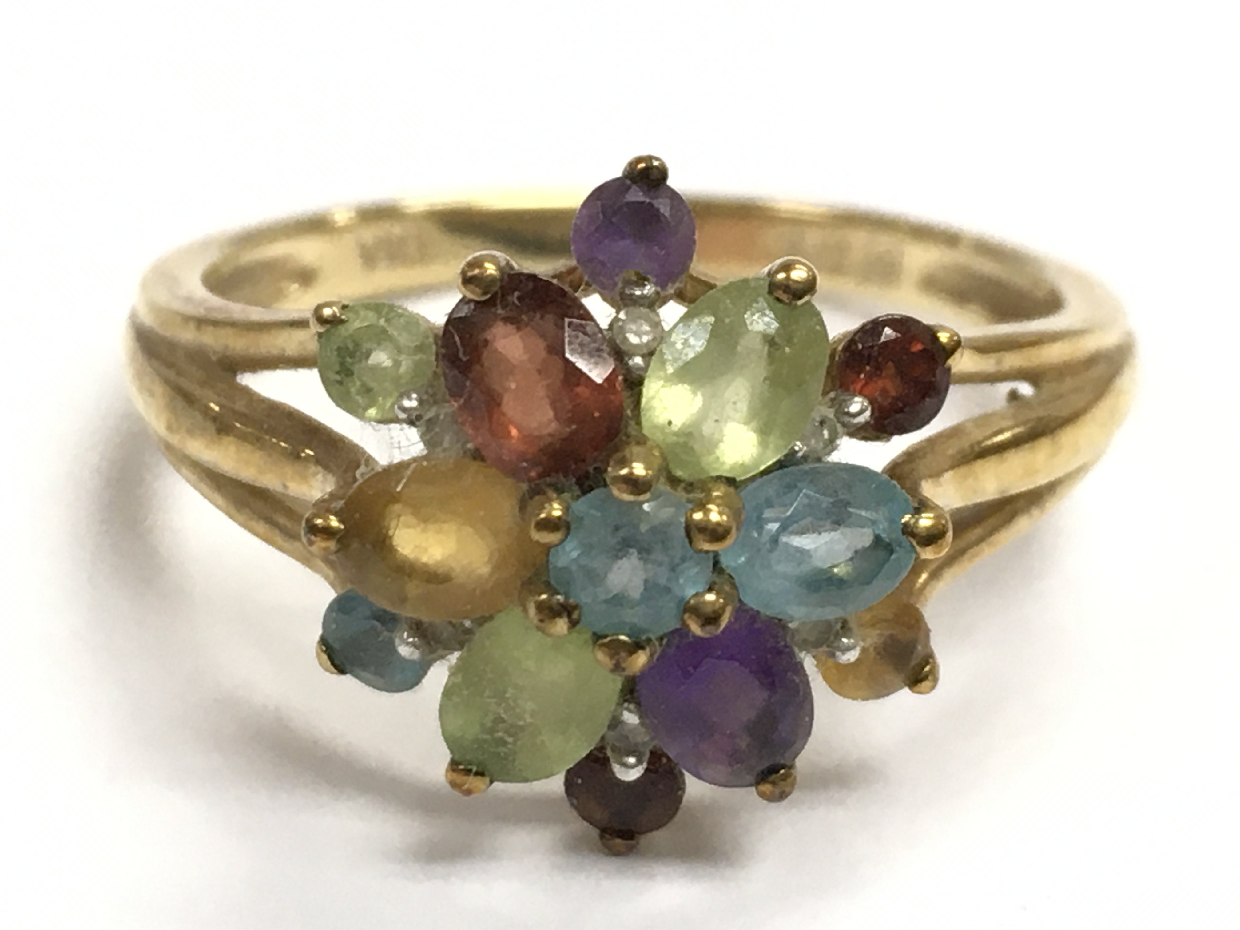 A 9 carat gold multi stone ring. 3g . Size Q.Postage category A