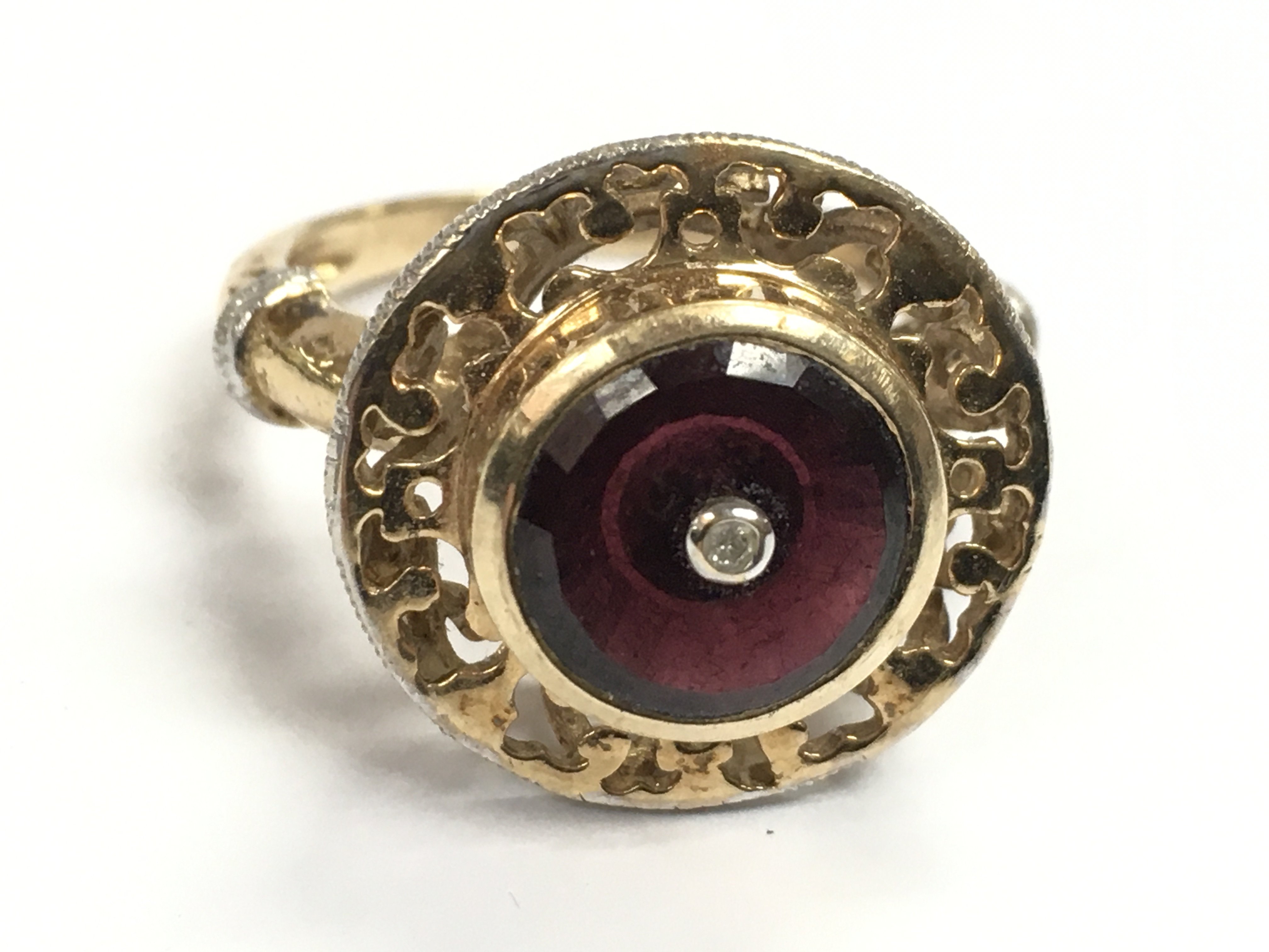 A 9 carat gold ruby ring inset with a diamond stone size S. 5.8g postage category A