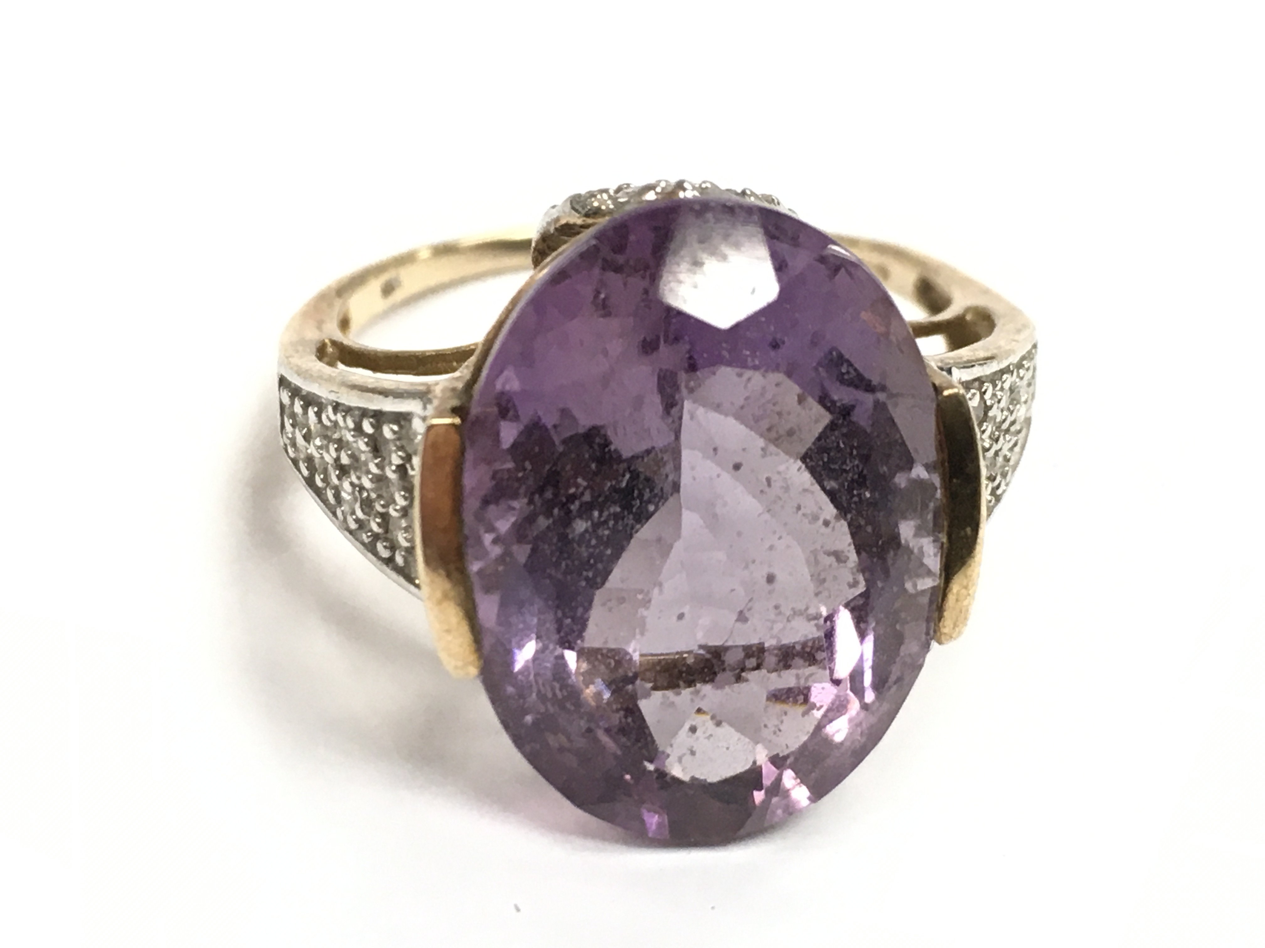 A 9 carat gold amethyst ring , 5.7g , size R postage category A