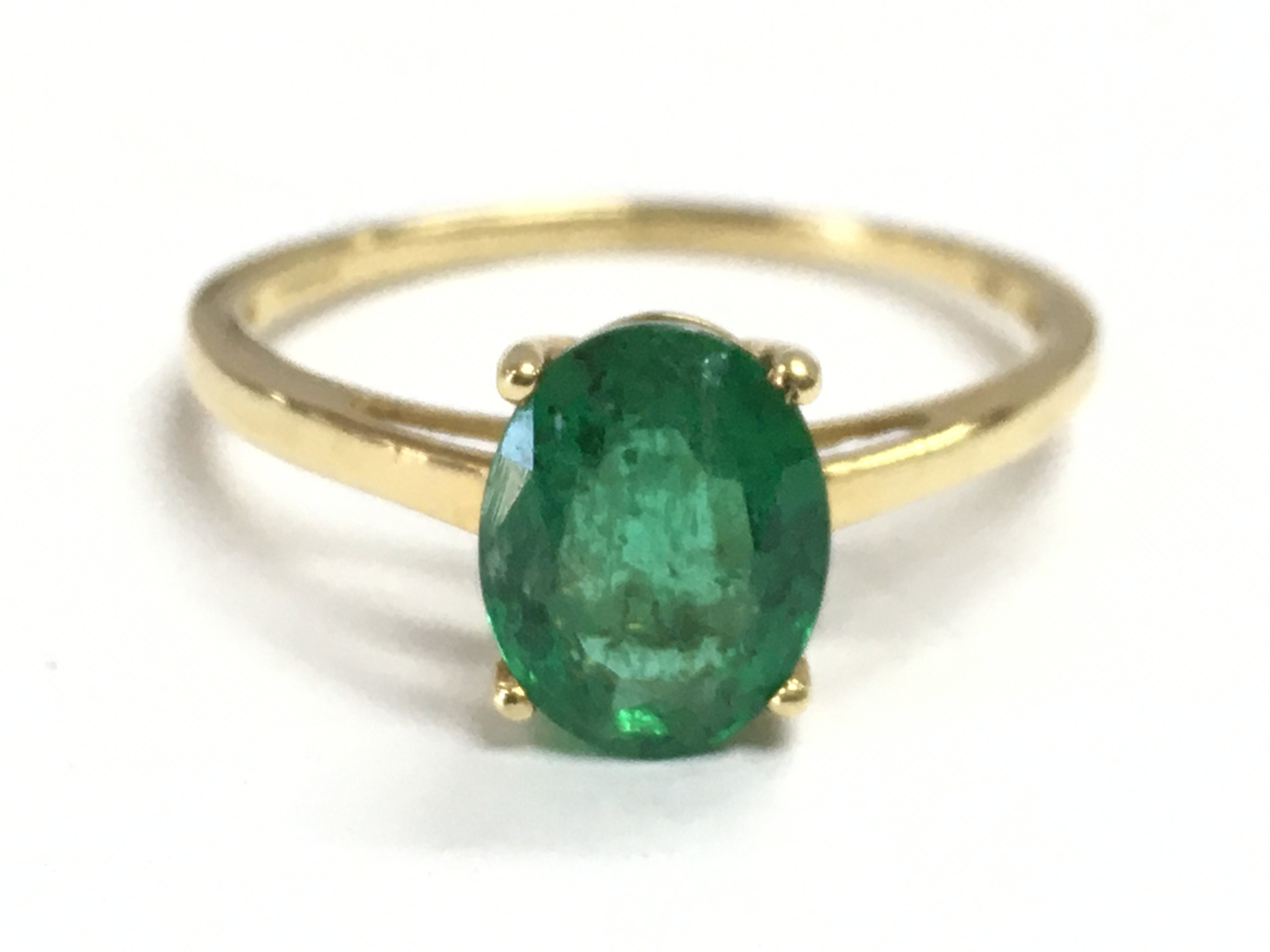 An 18ct gold emerald solitaire ring , 2.3g total weight. Size S Postage category A