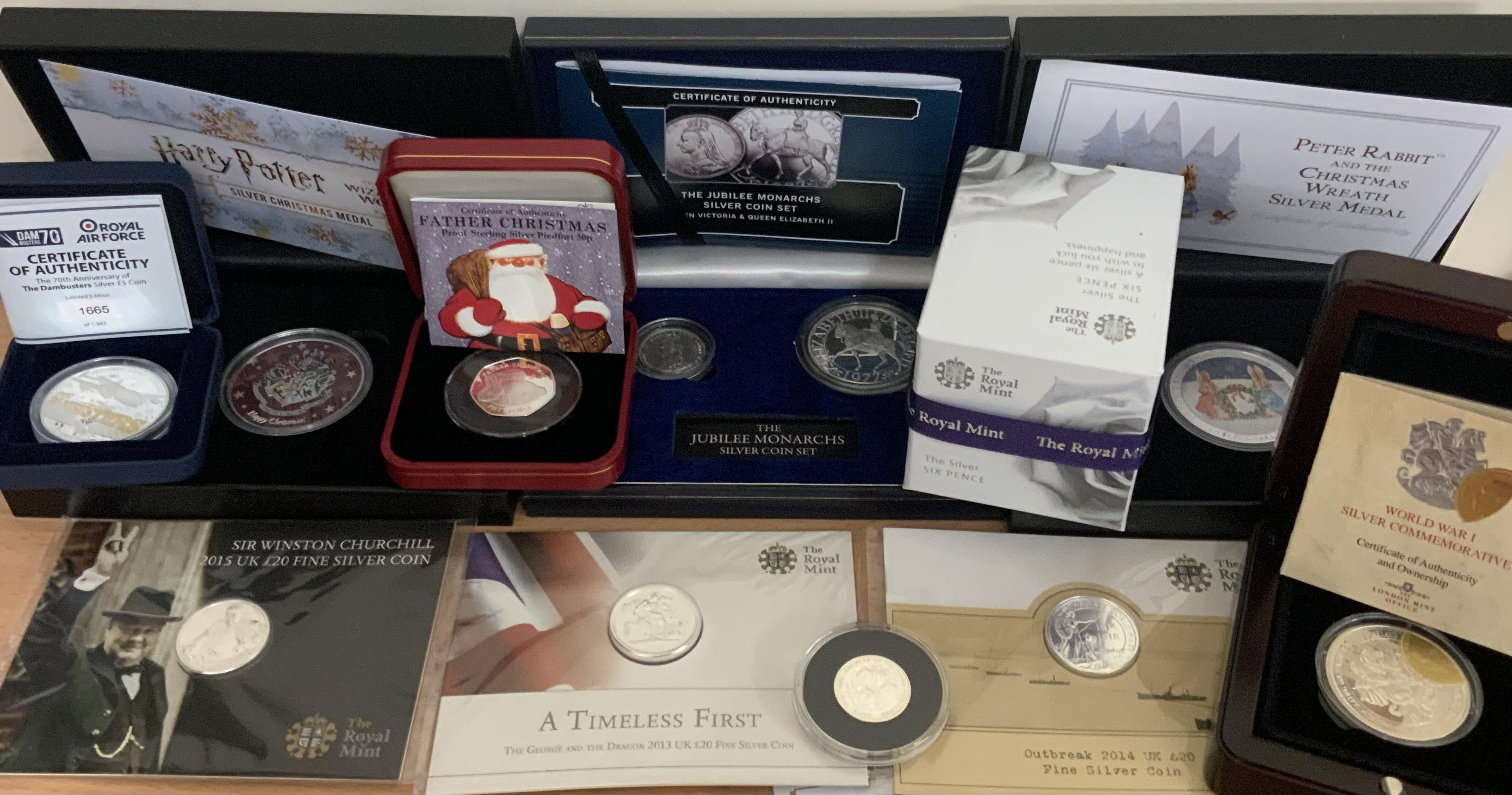 A collection of silver commemorative cased coinage. (A)
