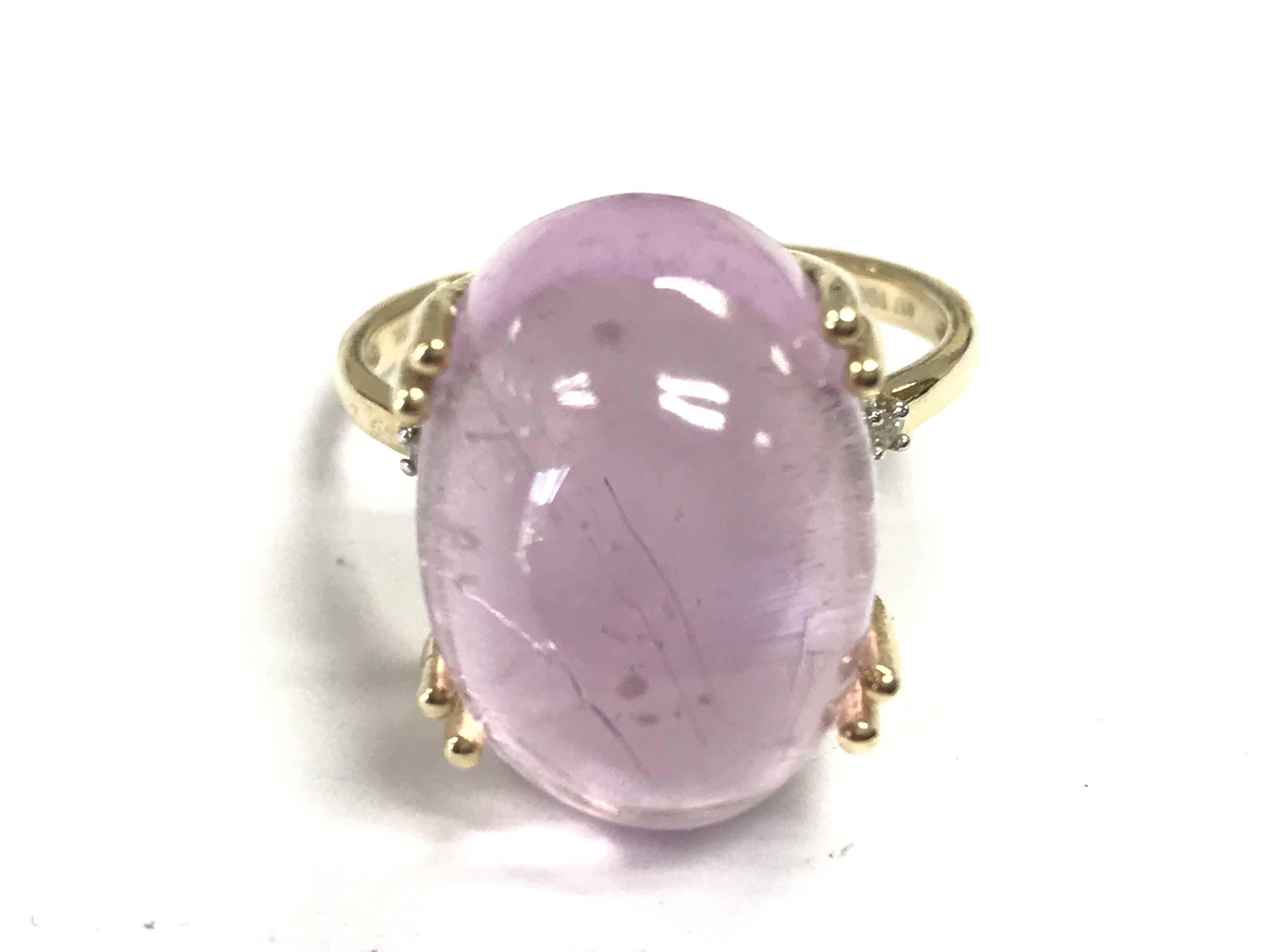 A pink stone 9ct gold ring, size R. 6.9g Postage category A
