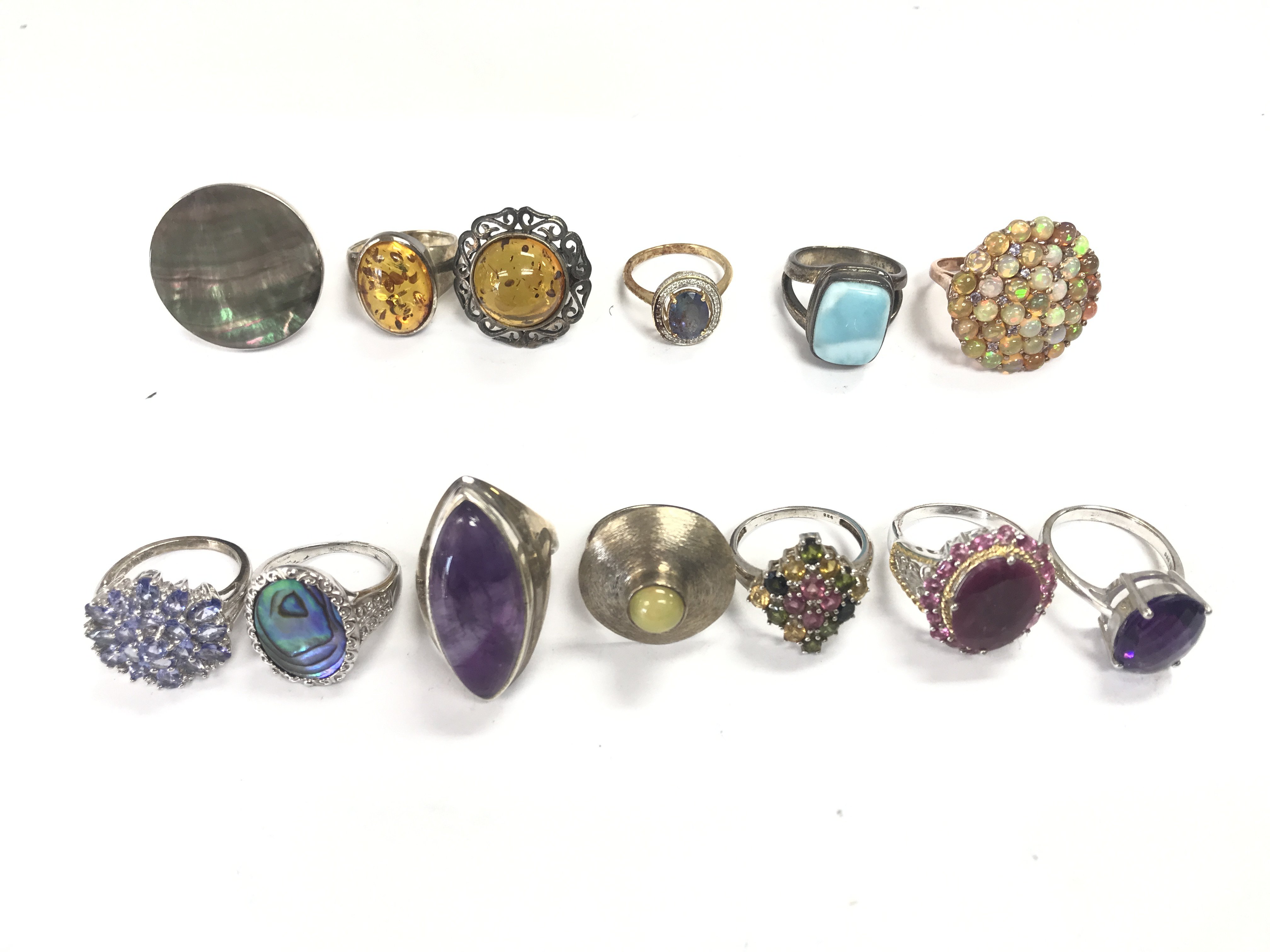 A collection of silver and costume rings . Postage cat A