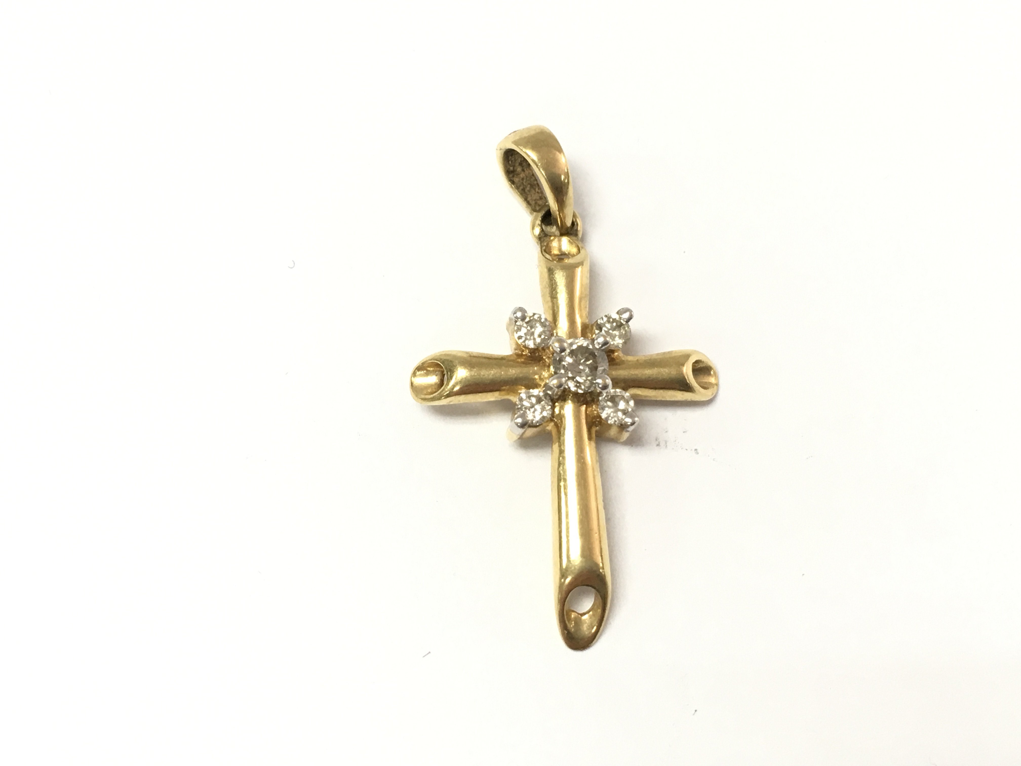 An 18ct gold diamond set cross pendant. 3.52g