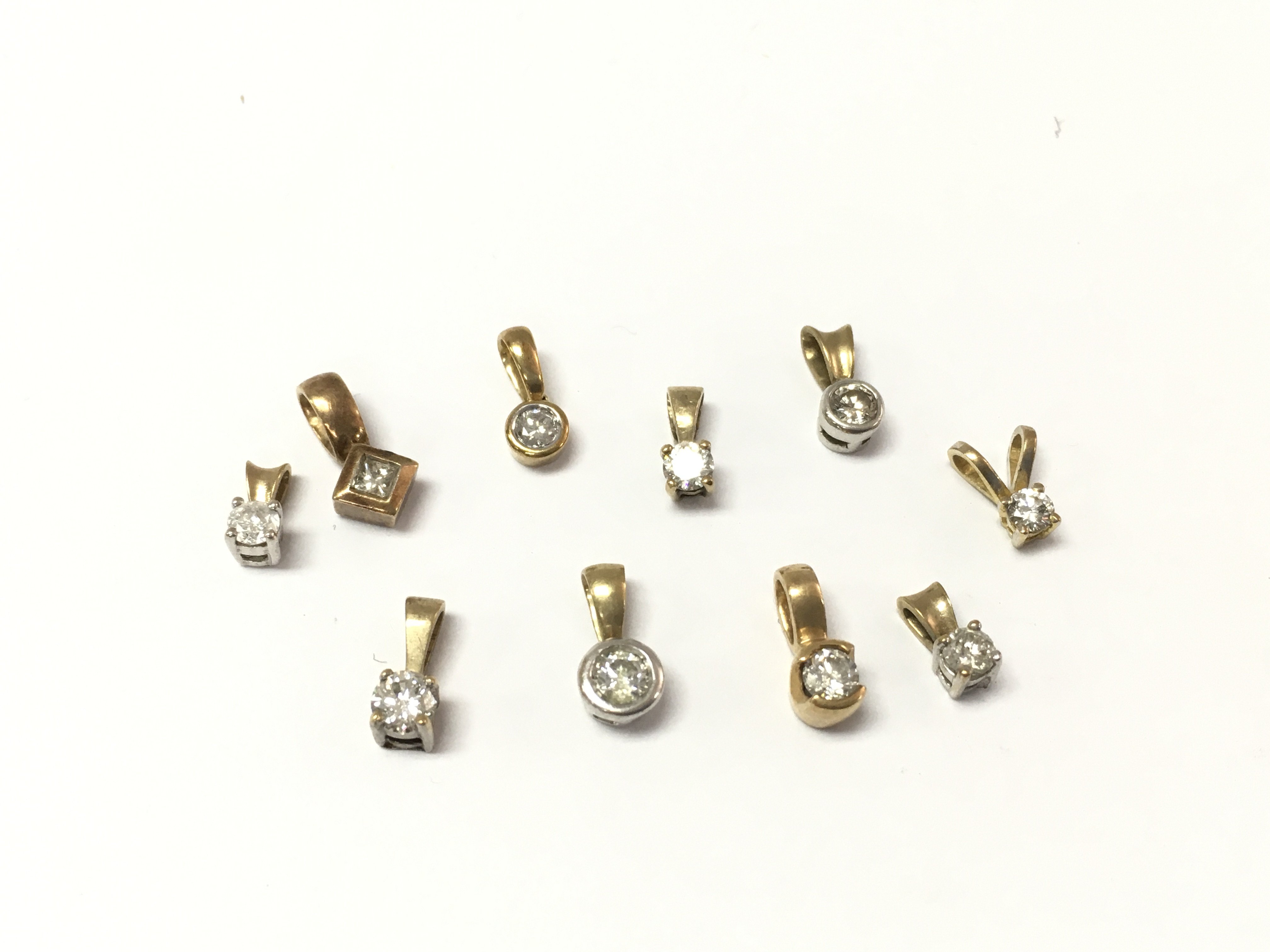 A collection of 9ct gold diamond pendants. 5.32g Postage A