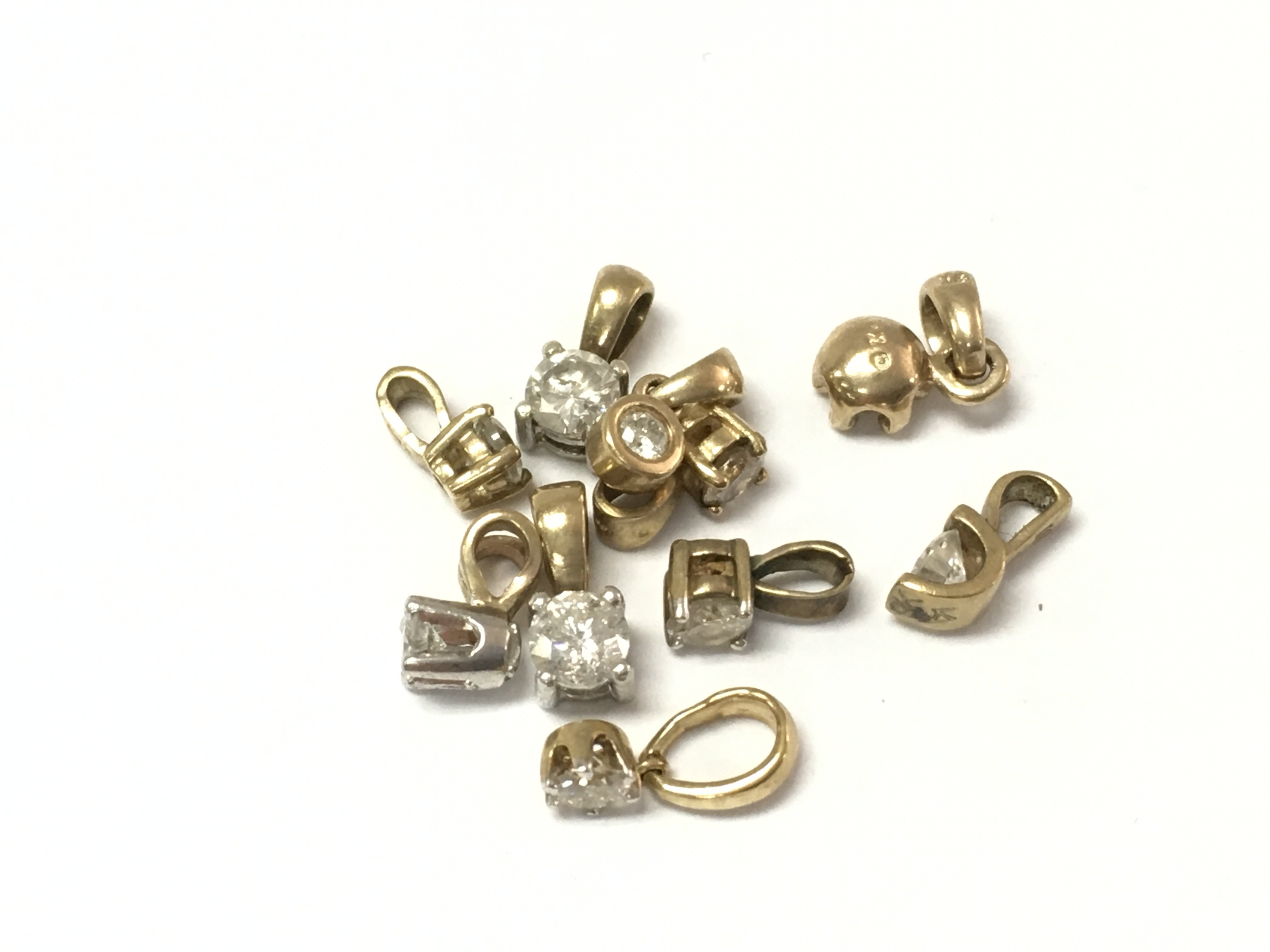 A collection of 9ct gold diamond pendants. 4.12g Postage A