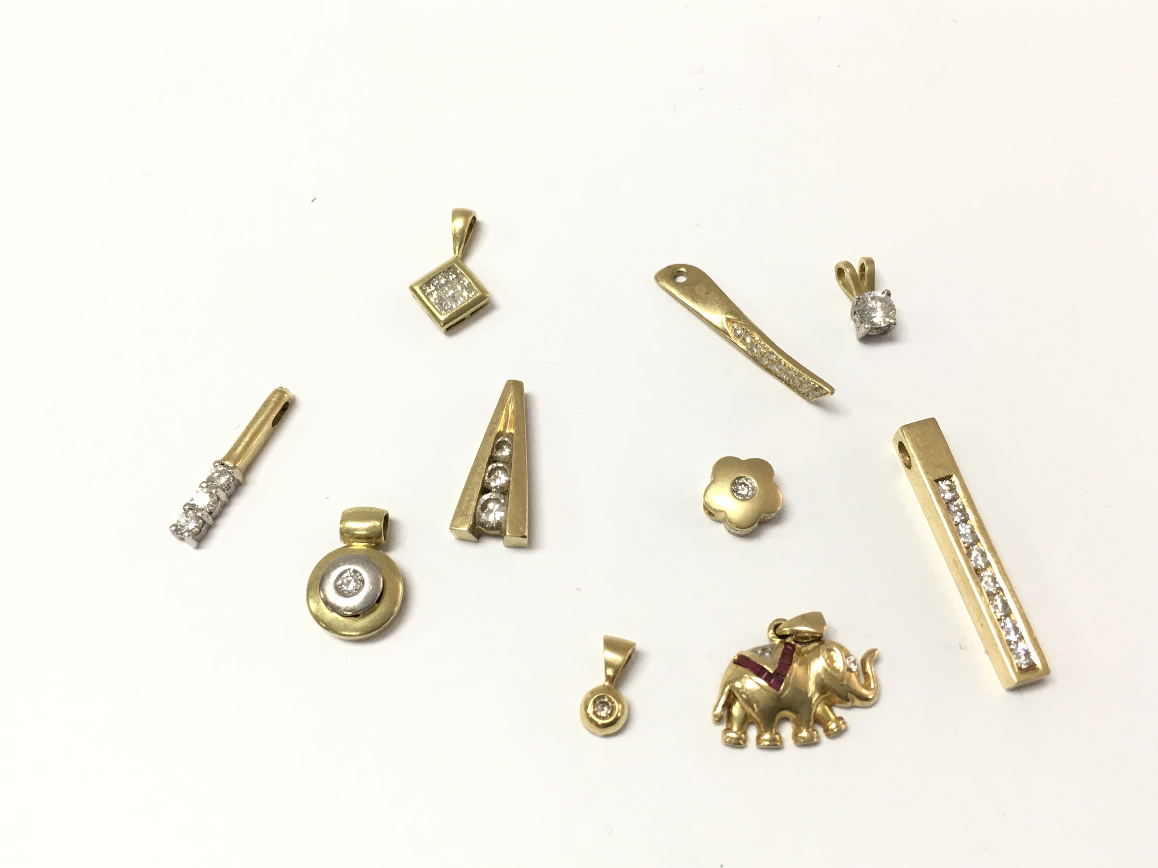 A collection of assorted 18ct gold diamond pendants. 16.93g