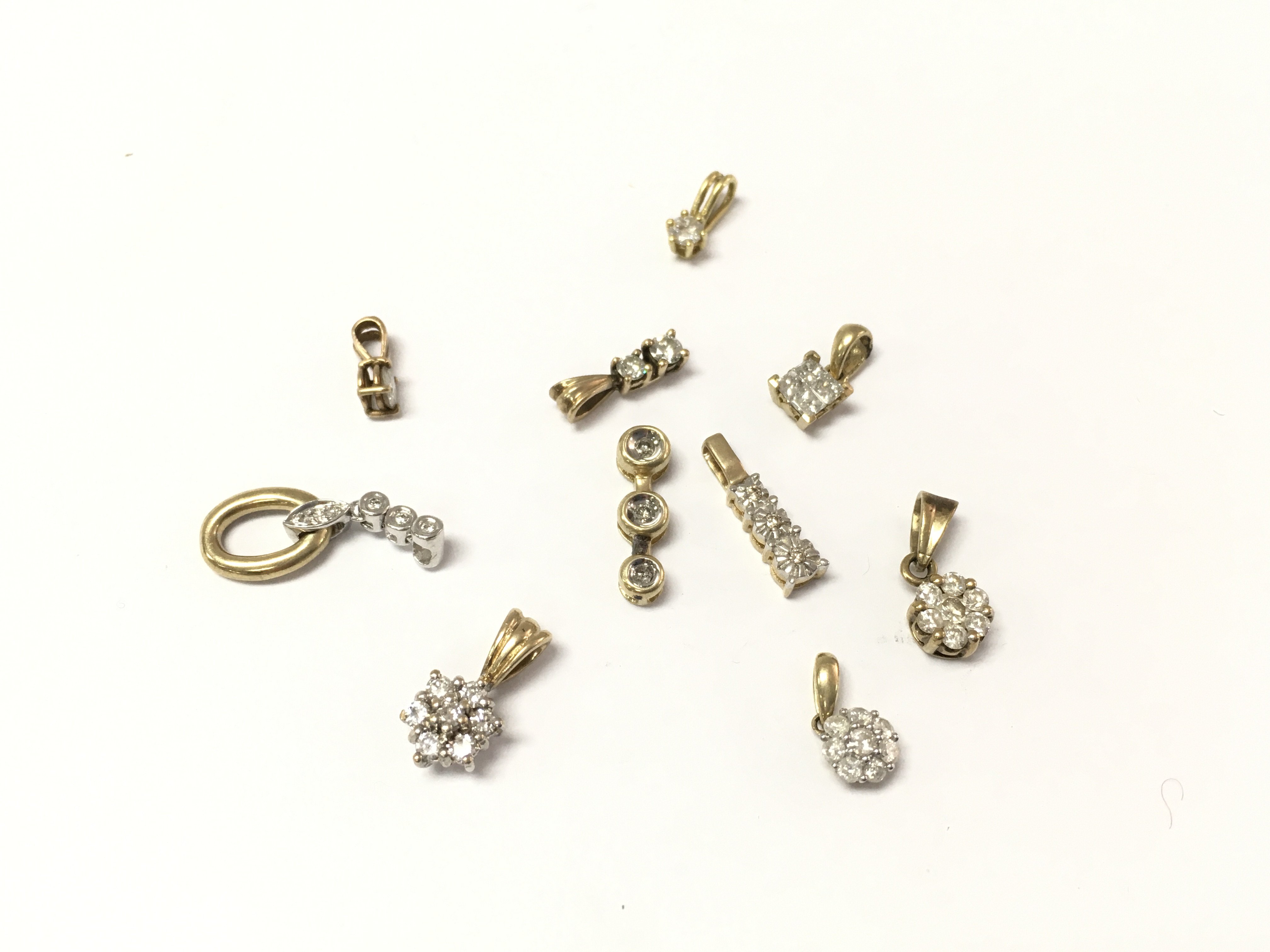 Collective lot of 9ct gold diamond pendants. 7.64g