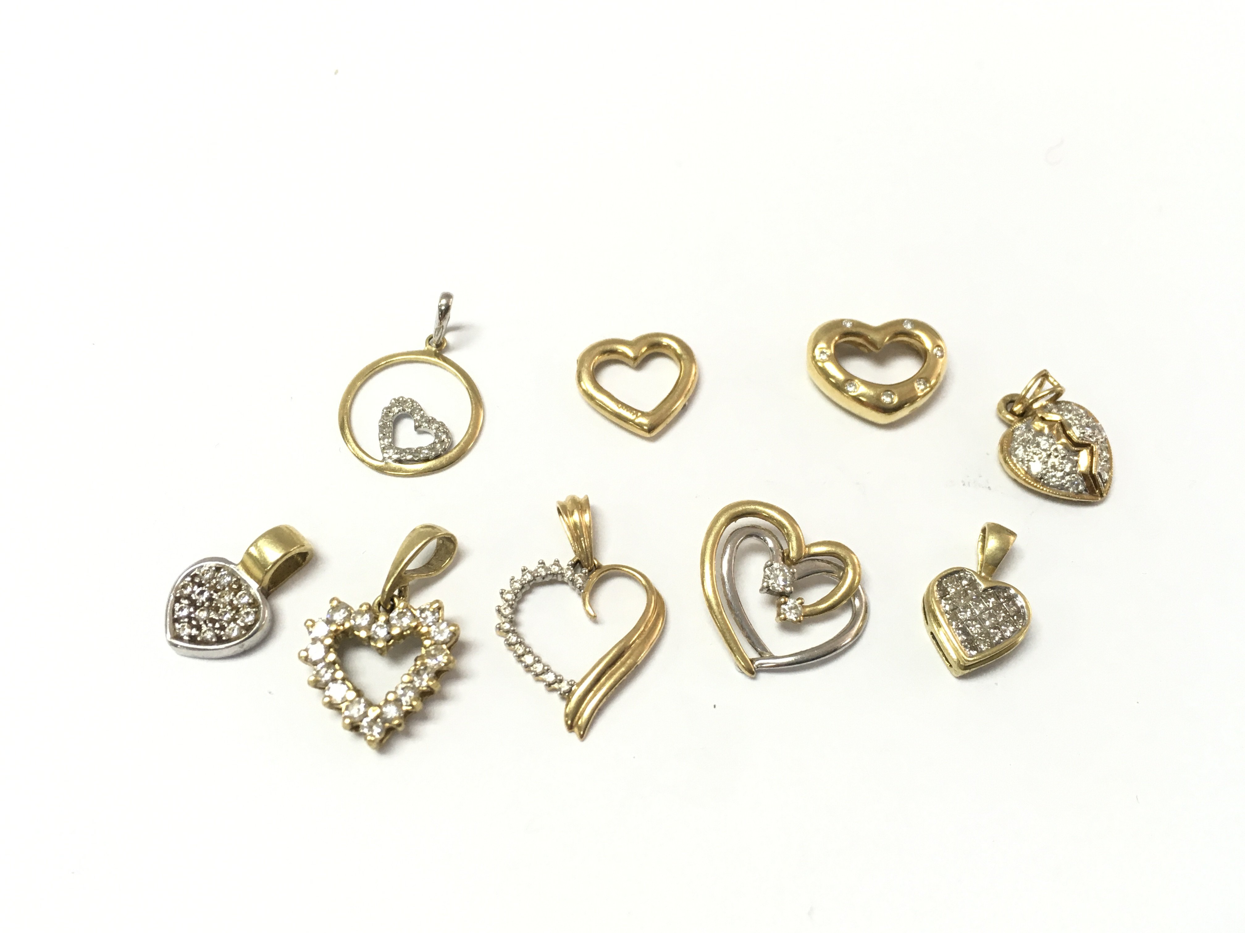 A collection of assorted 18ct gold heart pendants. 12.30g