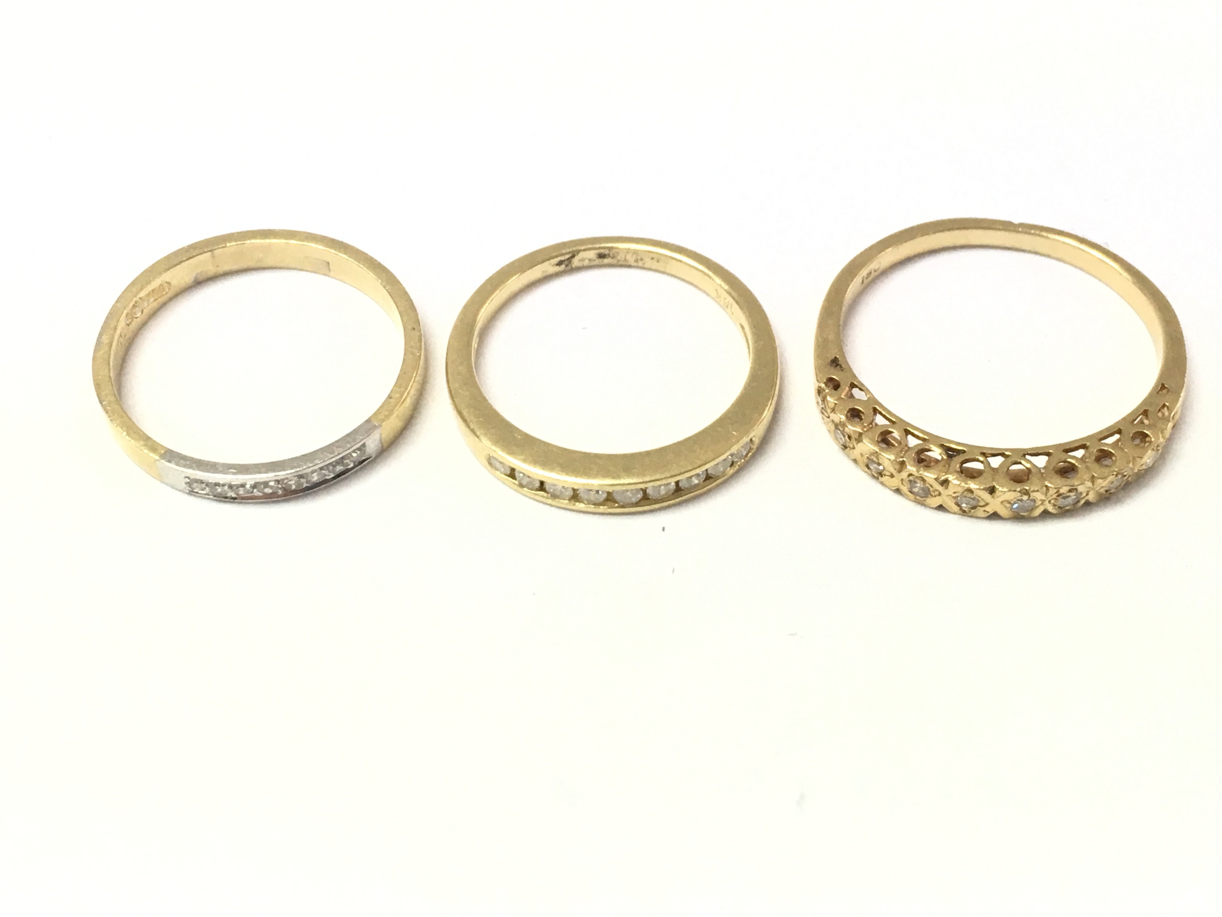Three 18ct gold diamond half hoop rings. 7.28g size K J and M
