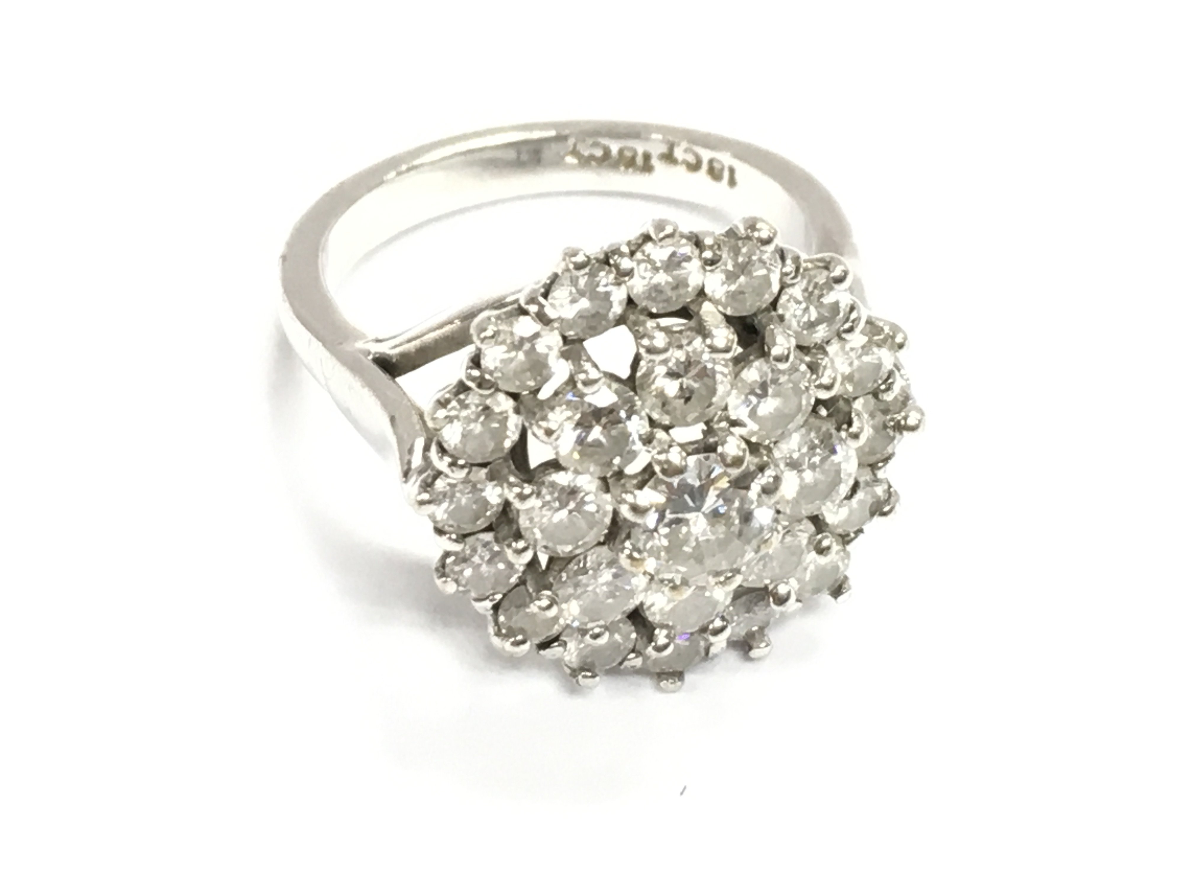 An 18ct white gold diamond cluster ring. Size N and 8.15g Central diamond is approximately 0.50ct and approximately 3.2ct total in diamonds