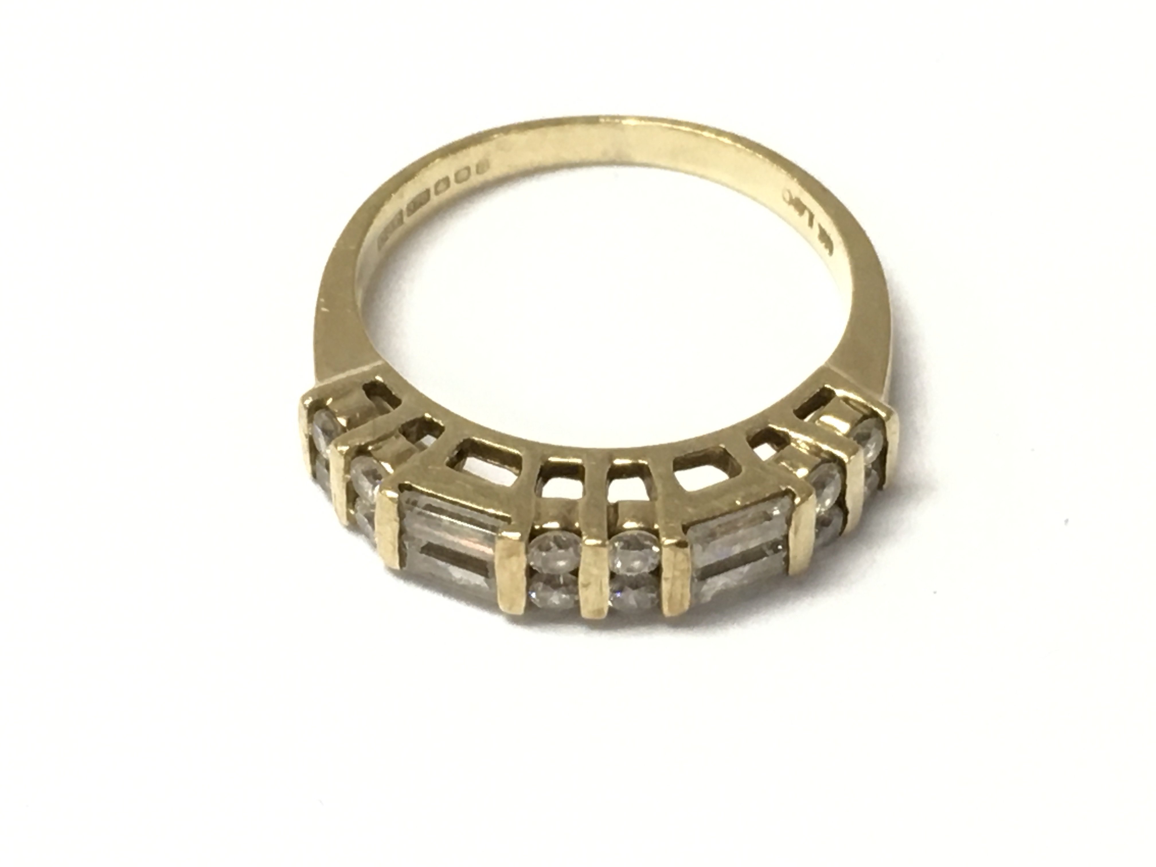 A 9ct gold baguette and round diamond half hoop rings. Size N and 3.3G Postage A