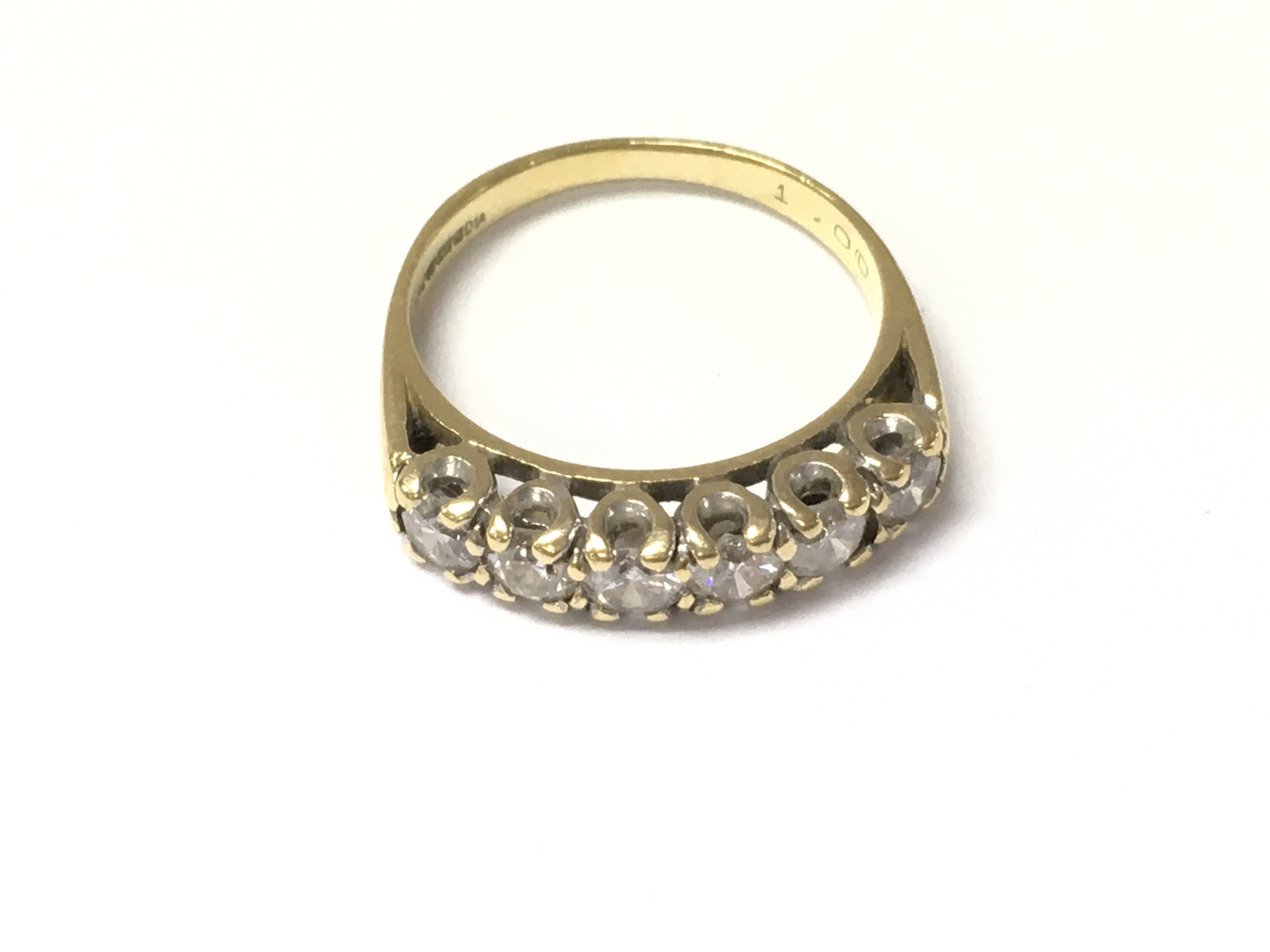 An 18ct gold six diamond set ring. Size M 1/2 and 3.88g Postage A